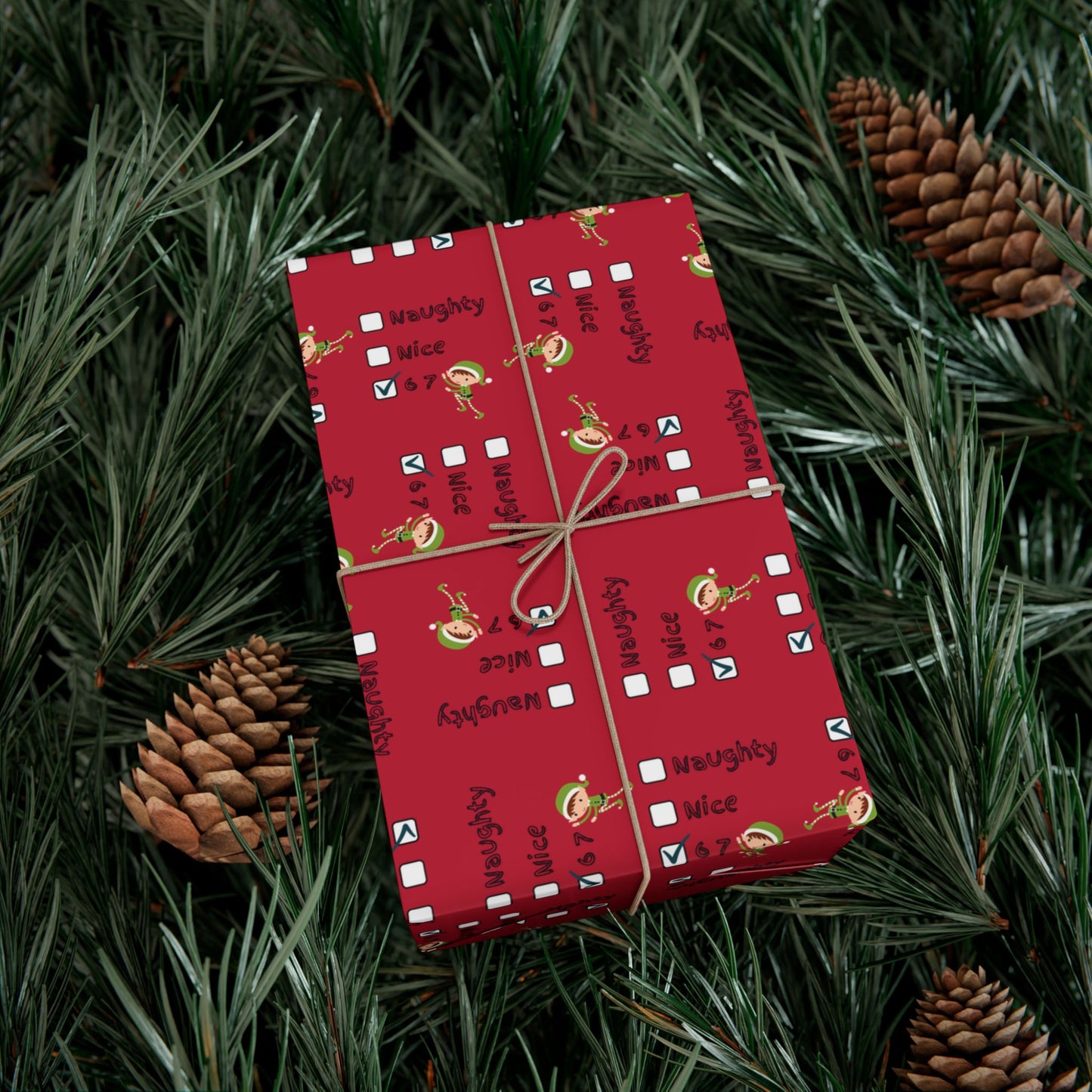 Festive red "Naughty Nice 67" Grinch wrapped present nestled in Christmas pine needles and cones