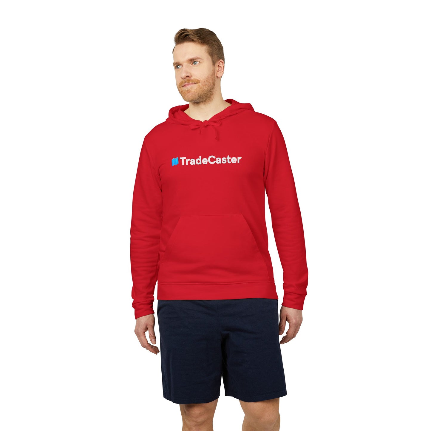 Bearded model rocking fiery red Adidas TradeCaster fleece hoodie with white "#TradeCaster" chest print and subtle sleeve logo, hood down, navy shorts