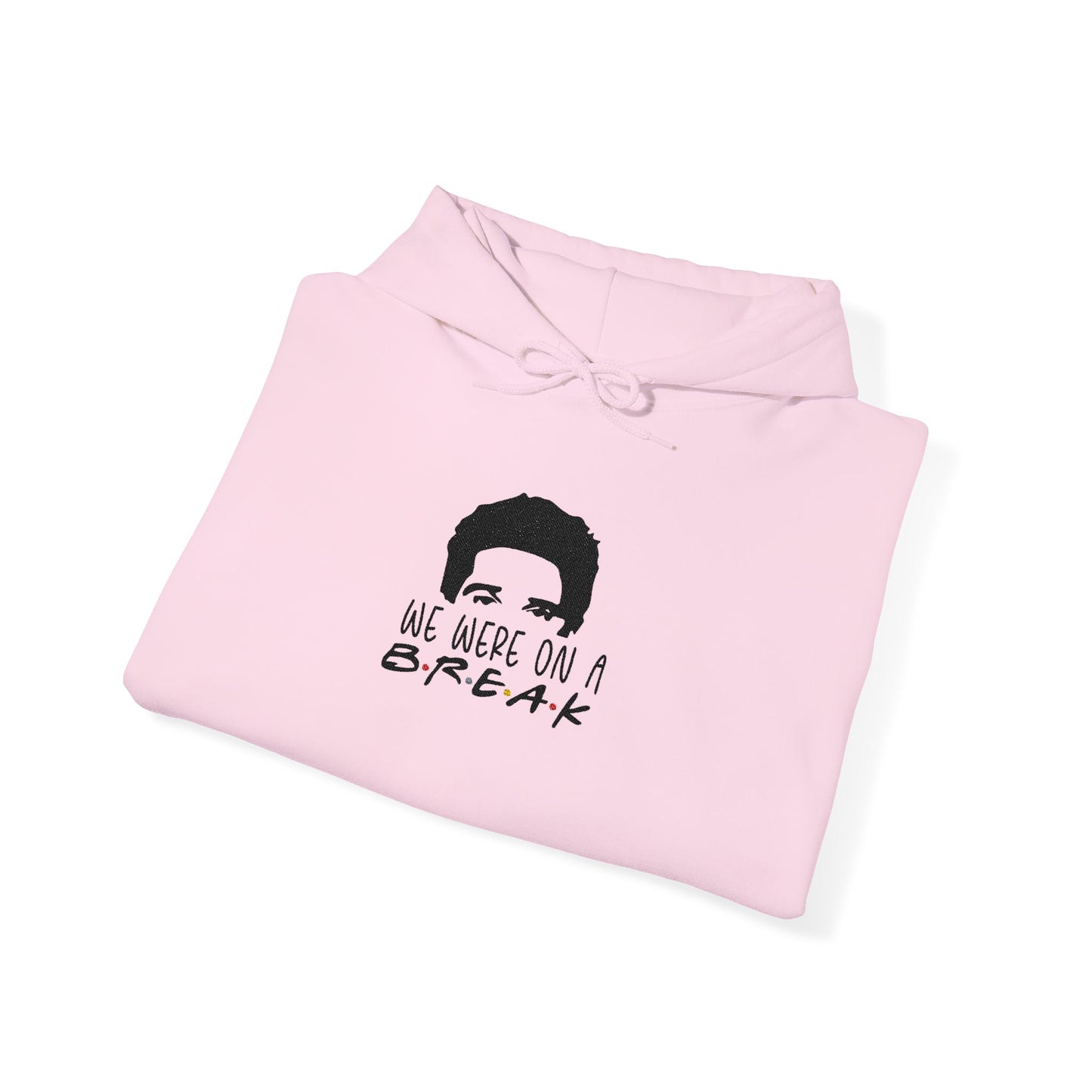Folded light pink hoodie showcasing black Ross silhouette and "We Were On A Break!" embroidery