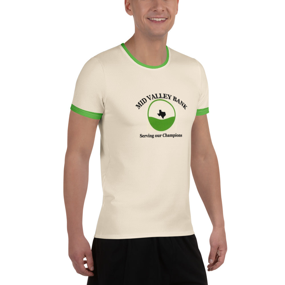 Three-quarter front view of smiling male model in cream athletic tee, green-trimmed sleeves/crewneck, bold "MID VALLEY BANK Serving our Champions" print