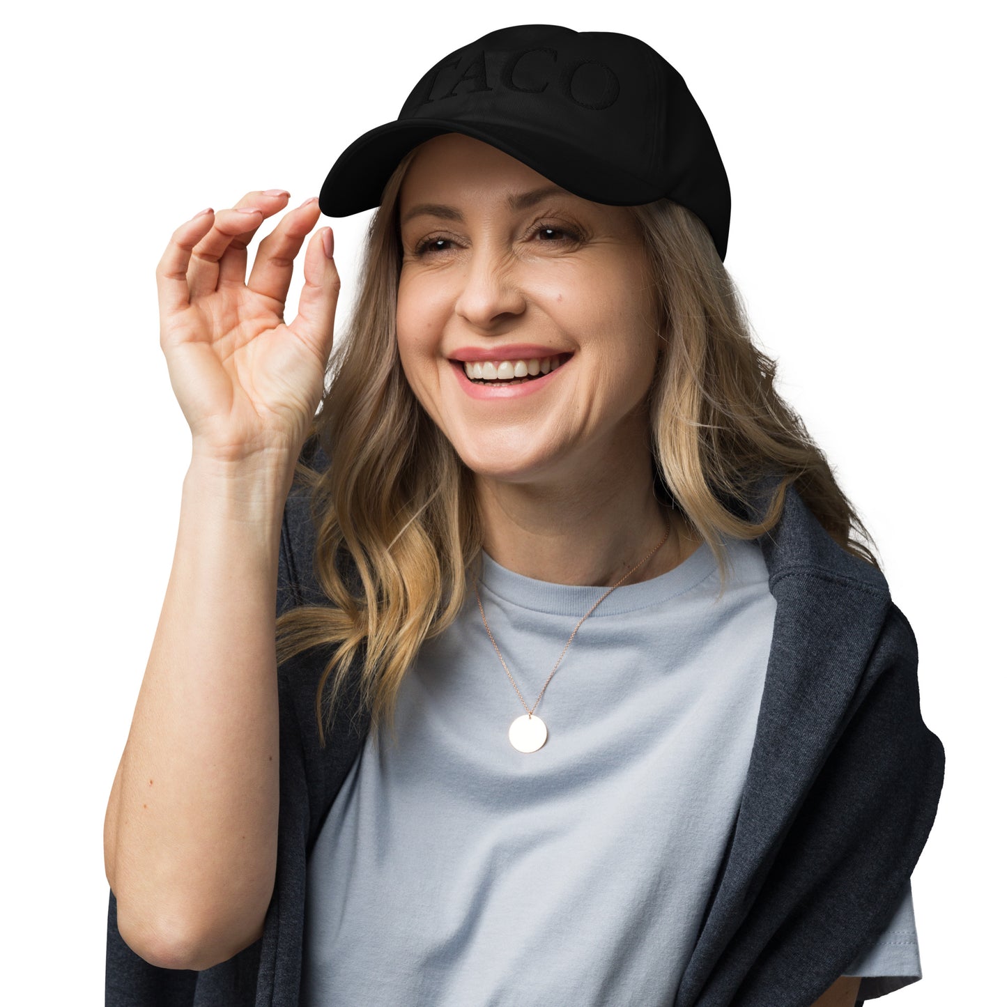 Three-quarter view of black "DARK TACO" dad hat on grinning blonde model gesturing playfully