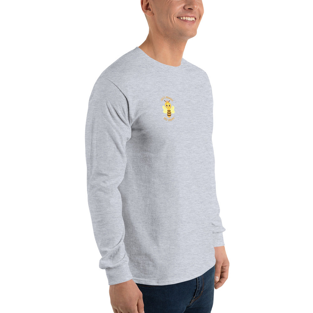 Close side view of male model in gray long-sleeve shirt highlighting yellow bee on chest