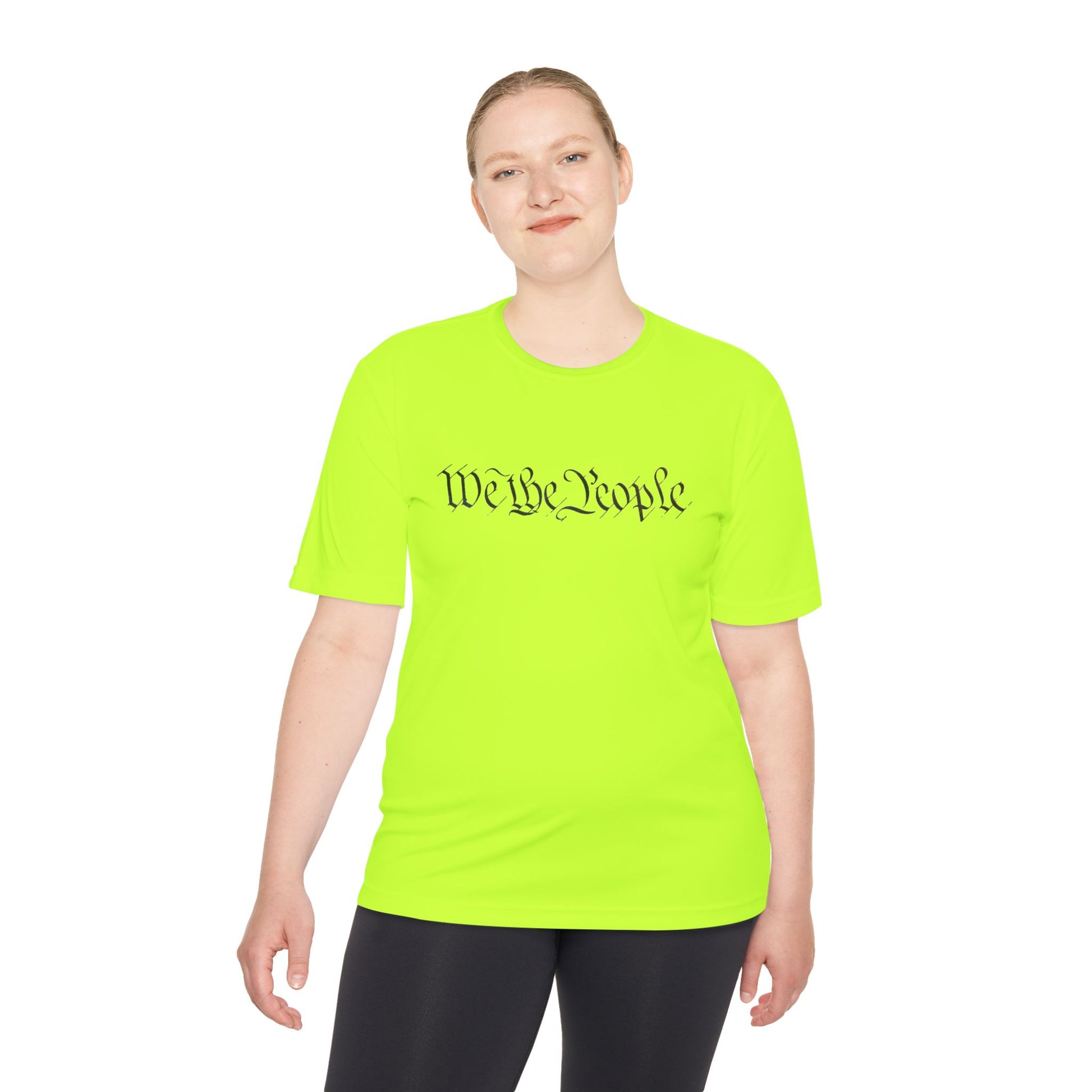 Female model grinning in neon green "We the People" script tee, perfect for patriotic workouts