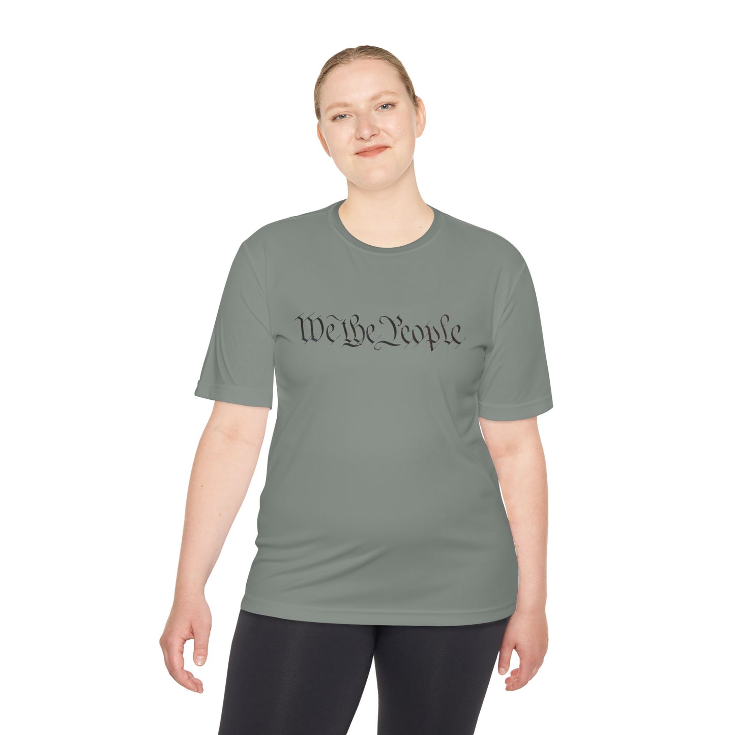 Female model in iron grey moisture-wicking tee featuring black cursive "We the People" print