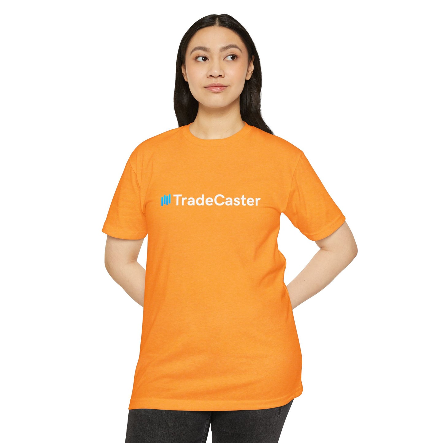 Female model front view in orange CVC TradeCaster tee with blue logo, hands on hips black pants