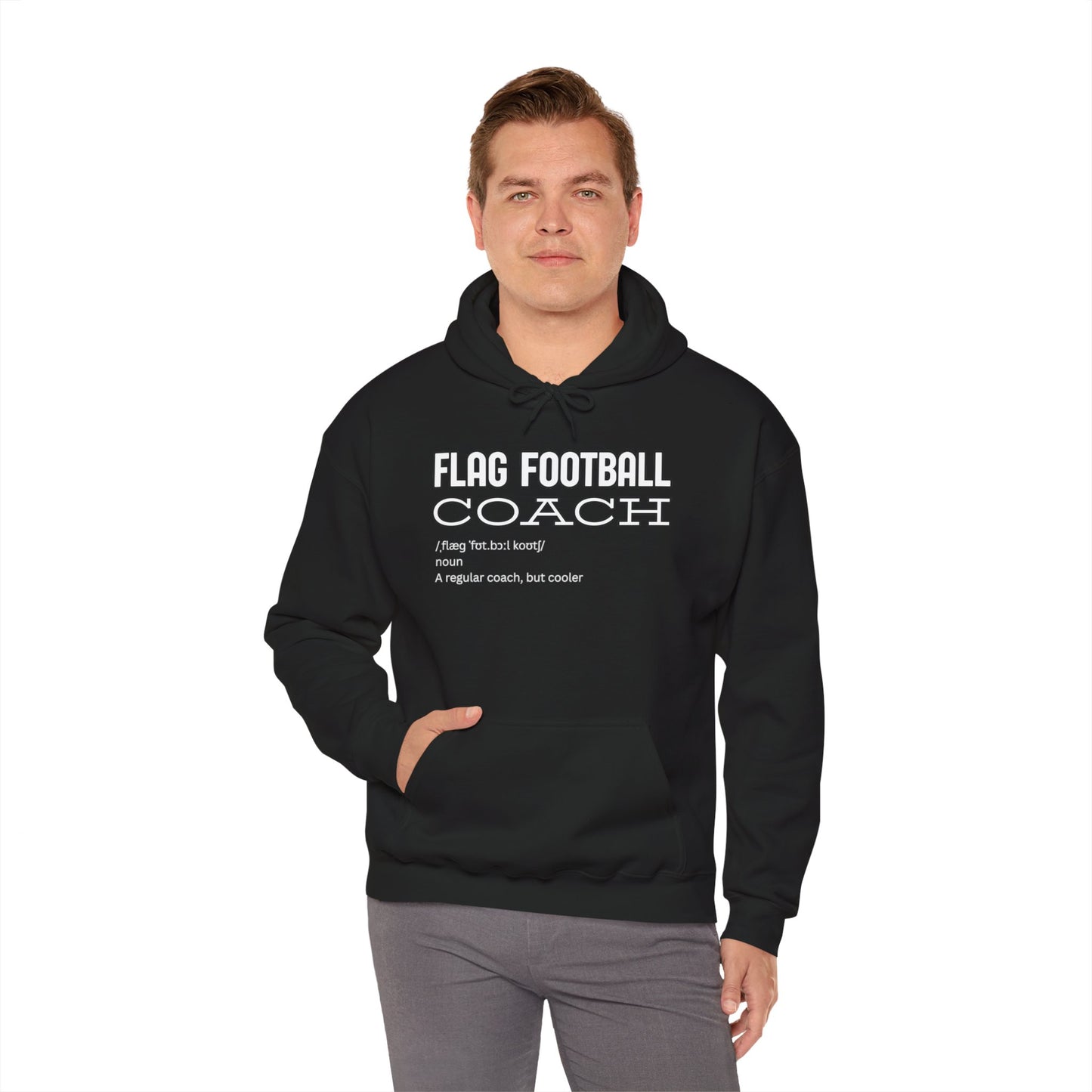 Man wearing black Flag Football Coach hoodie front view, pocketed hands, chill style
