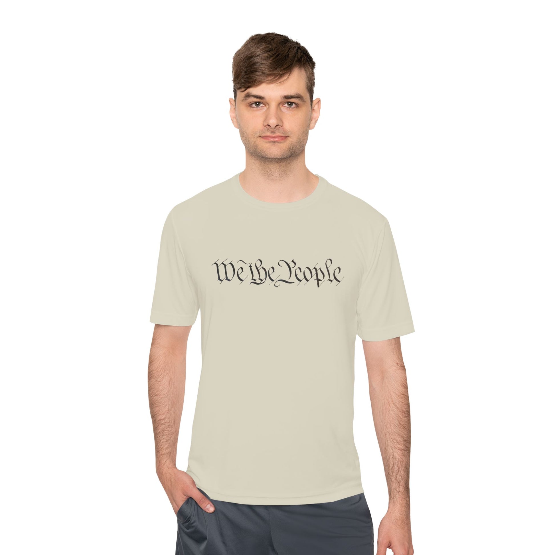Dude in cream tee rocking front "We the People" black script, hands in pockets