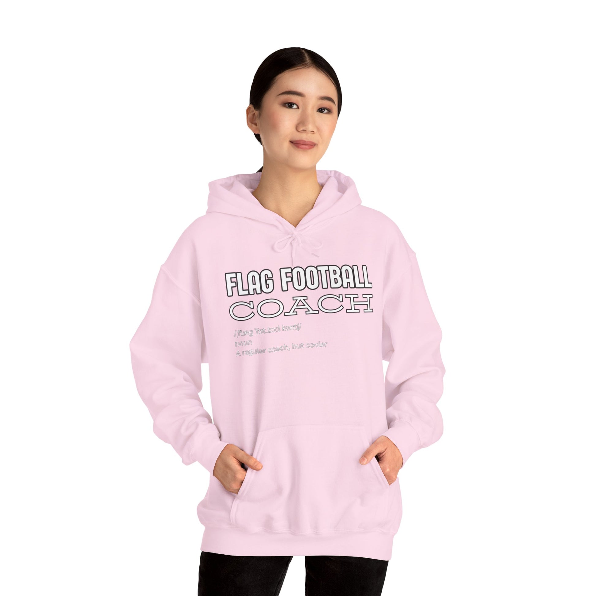 Asian female model in light pink "Flag Football Coach" hoodie front view, hands casually in pockets