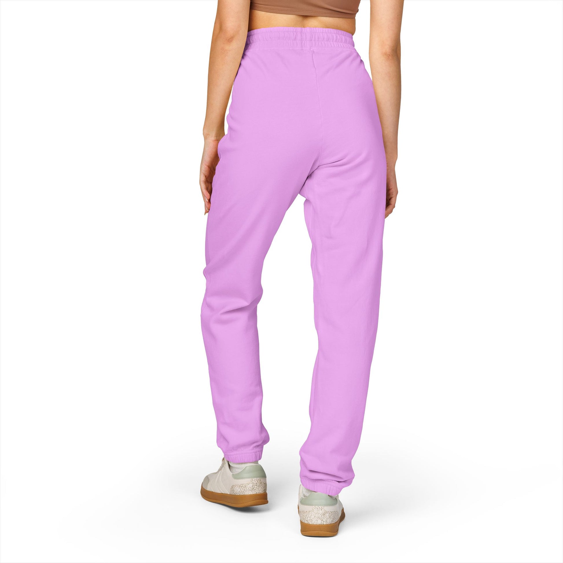 Back view of model in purple fleece joggers, relaxed taper at ankles, paired with white sneakers
