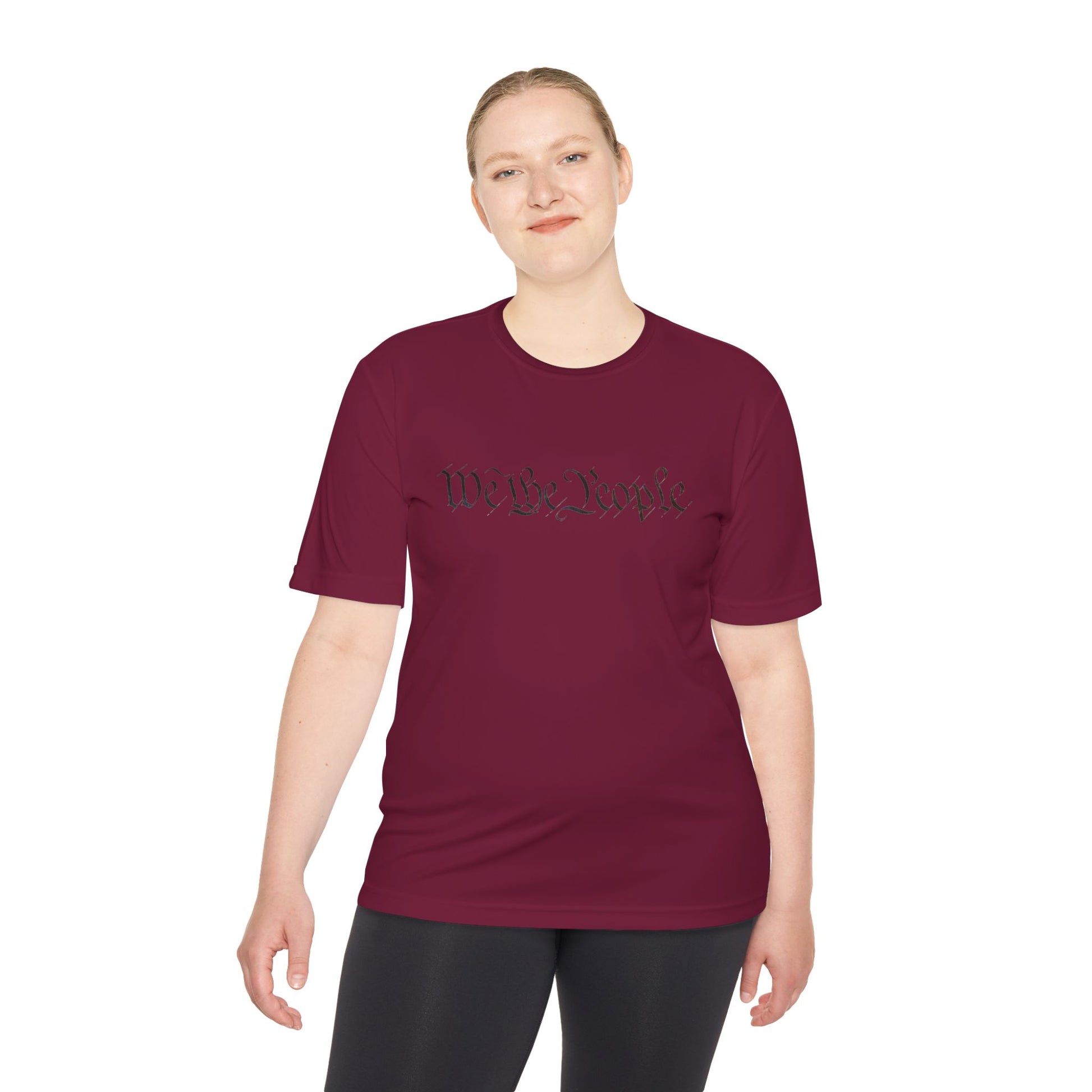 Female model front view in maroon athletic tee featuring black cursive "We the People" script