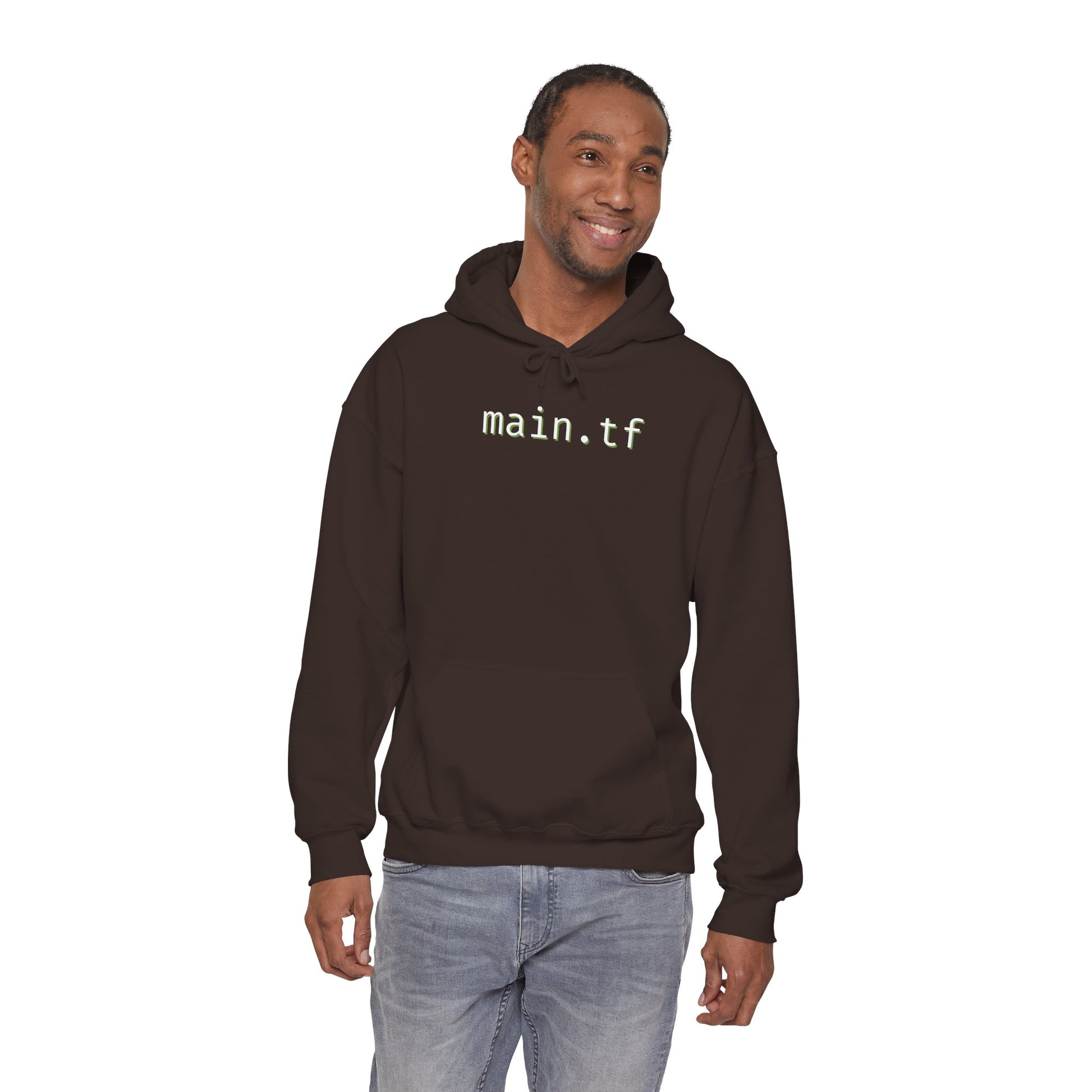 Smiling man in front view of dark heather gray "main.tf" hoodie, light cyan text, casual jeans pose