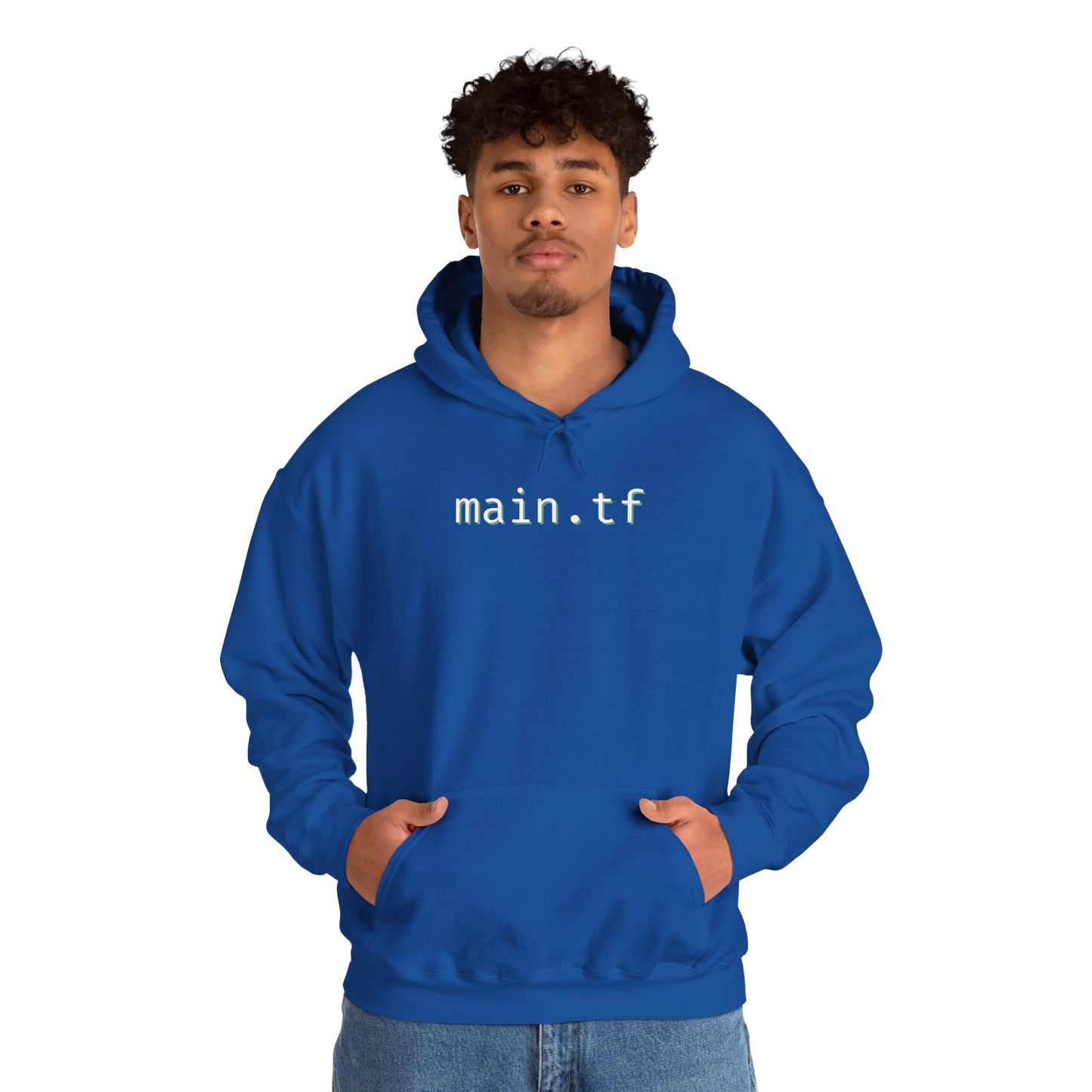 Curly-haired male model in royal blue "main.tf" hoodie front view, hands out, jeans style