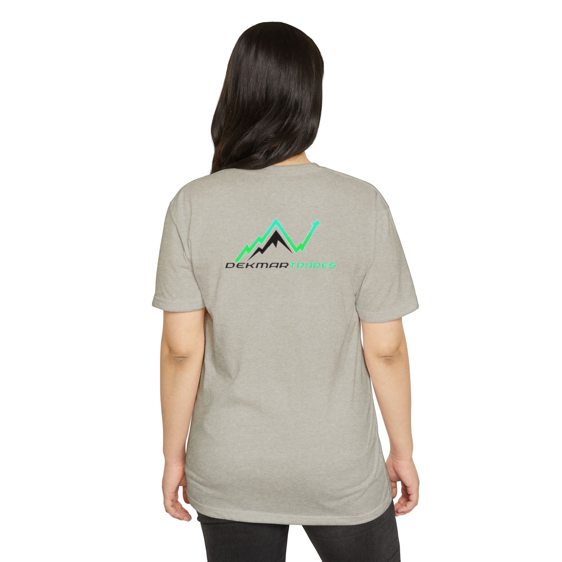 Female model wearing heather gray TradeCaster tee from back, Dekmar Trades emblem in green peaks