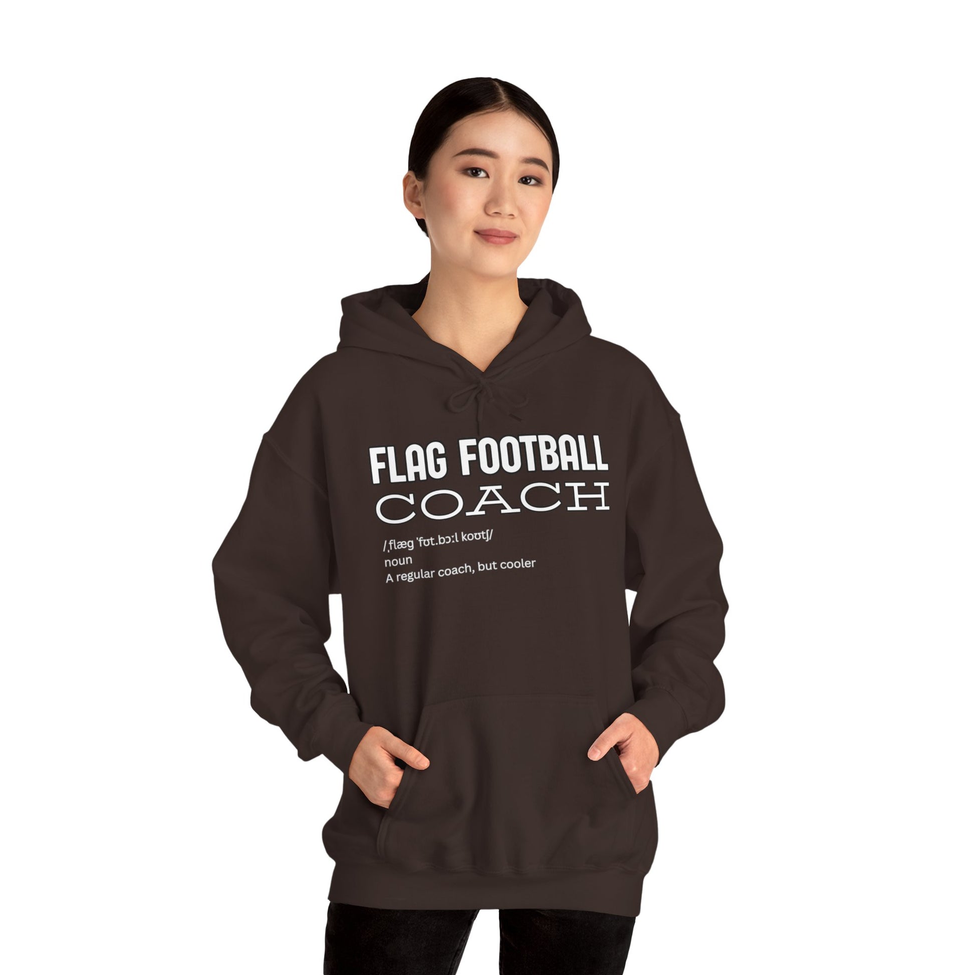 Female model in dark chocolate Flag Football Coach hoodie, front view with white print