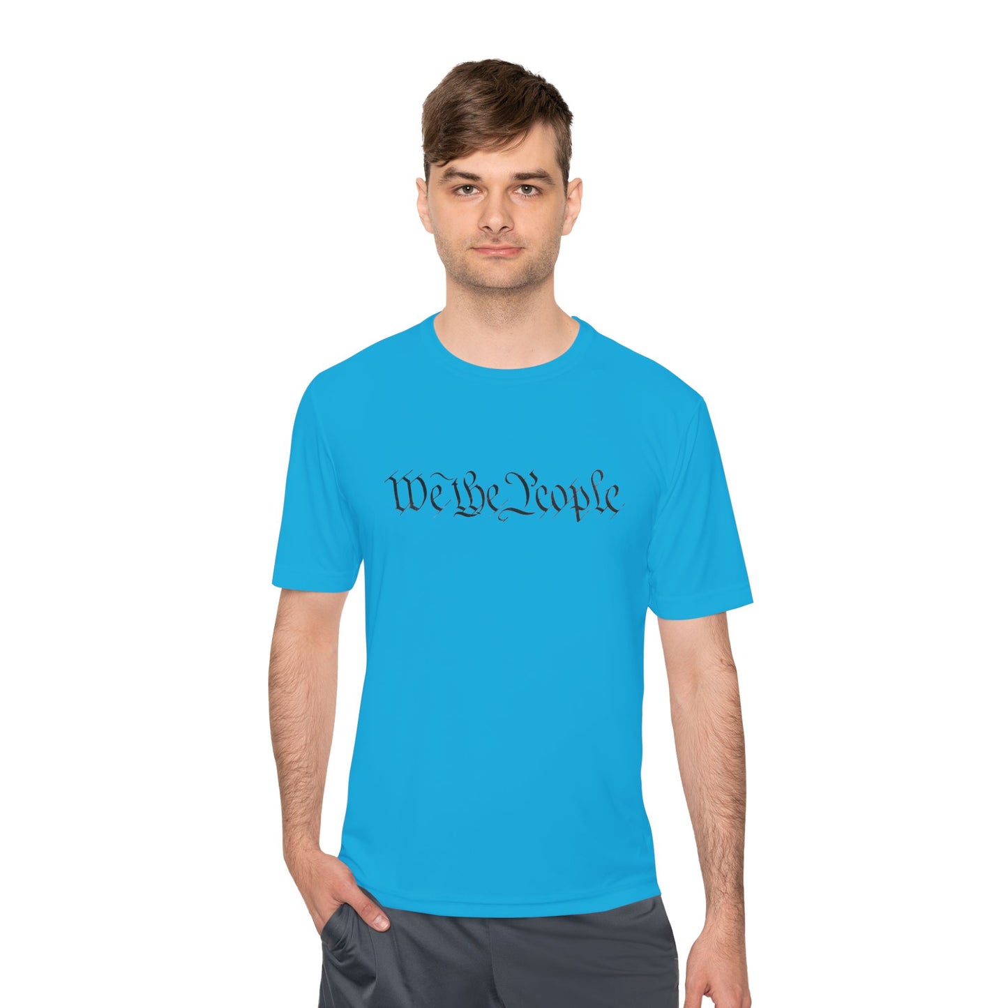 Male model in atomic blue moisture-wicking tee with bold "We the People" script front
