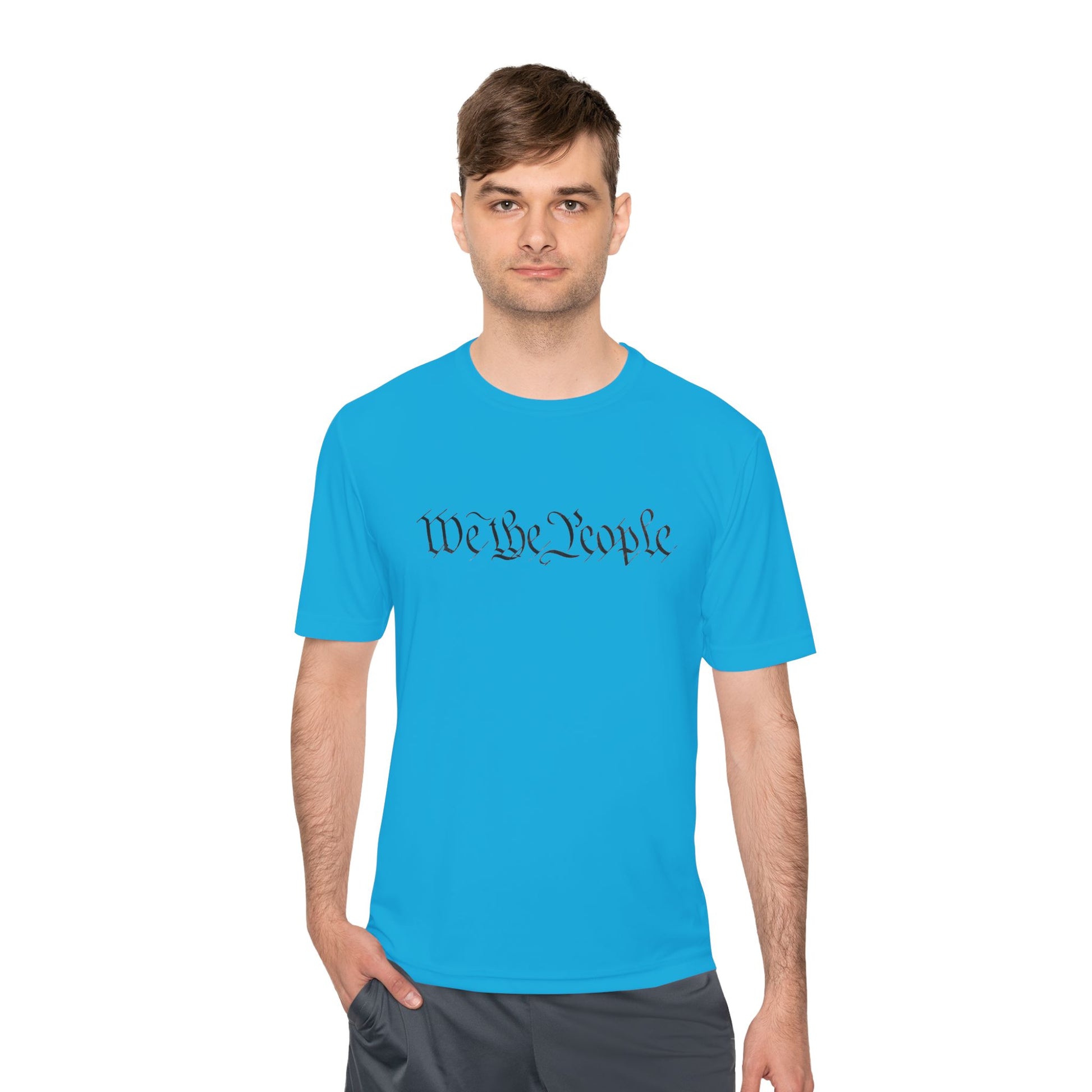 Male model in atomic blue moisture-wicking tee with bold "We the People" script front