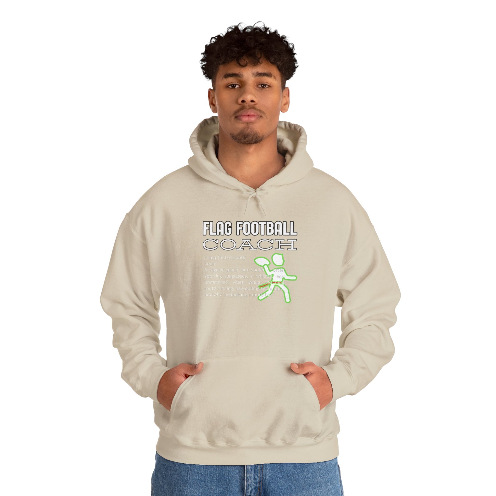 Curly-haired male model flexing light beige Flag Football Coach hoodie front, casual jeans vibe