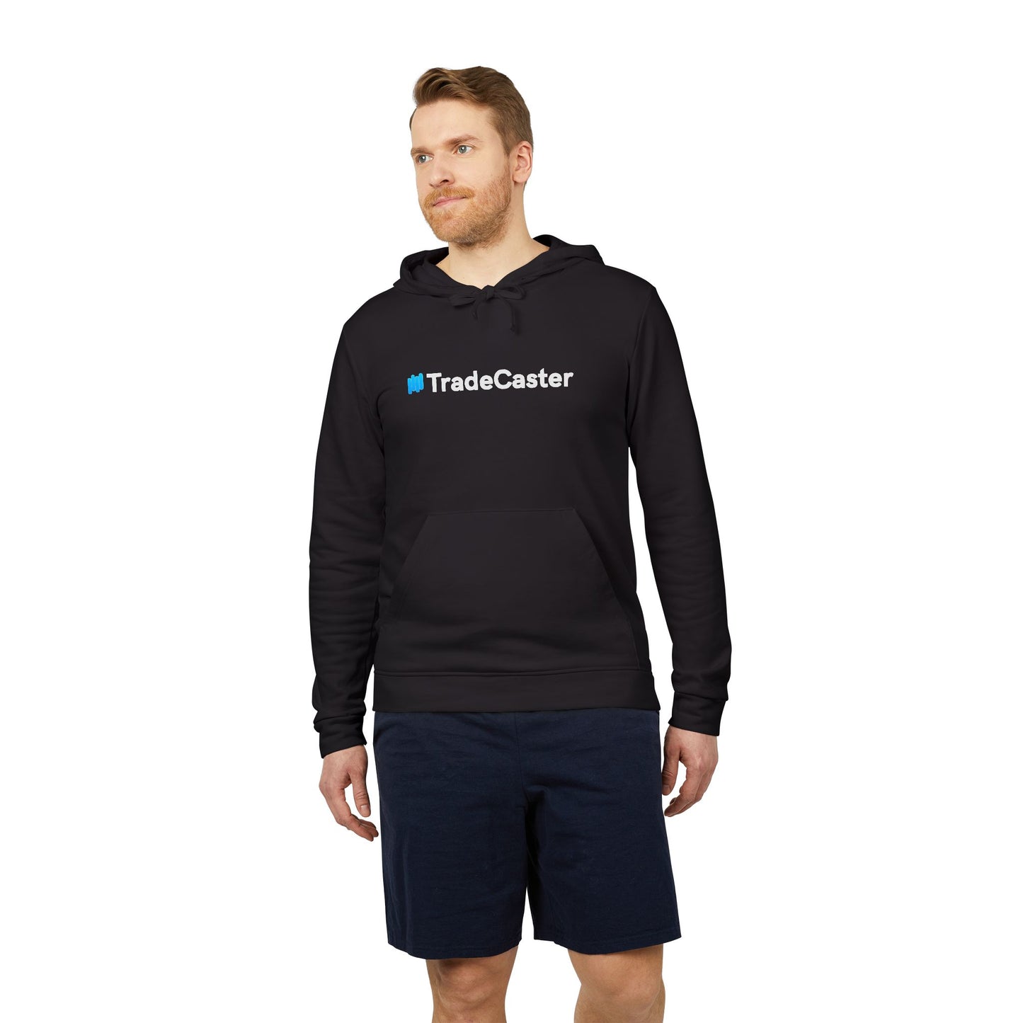 Male model glancing up in navy fleece hoodie, bold white #TradeCaster chest print, navy shorts