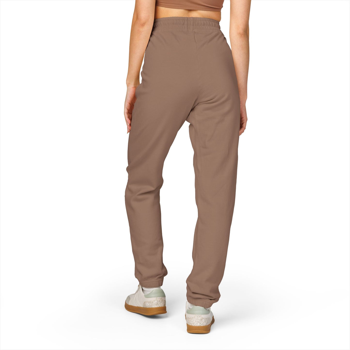 Back view of model in cozy taupe Zeta sweatpants, relaxed fit with ankle taper and white sneakers
