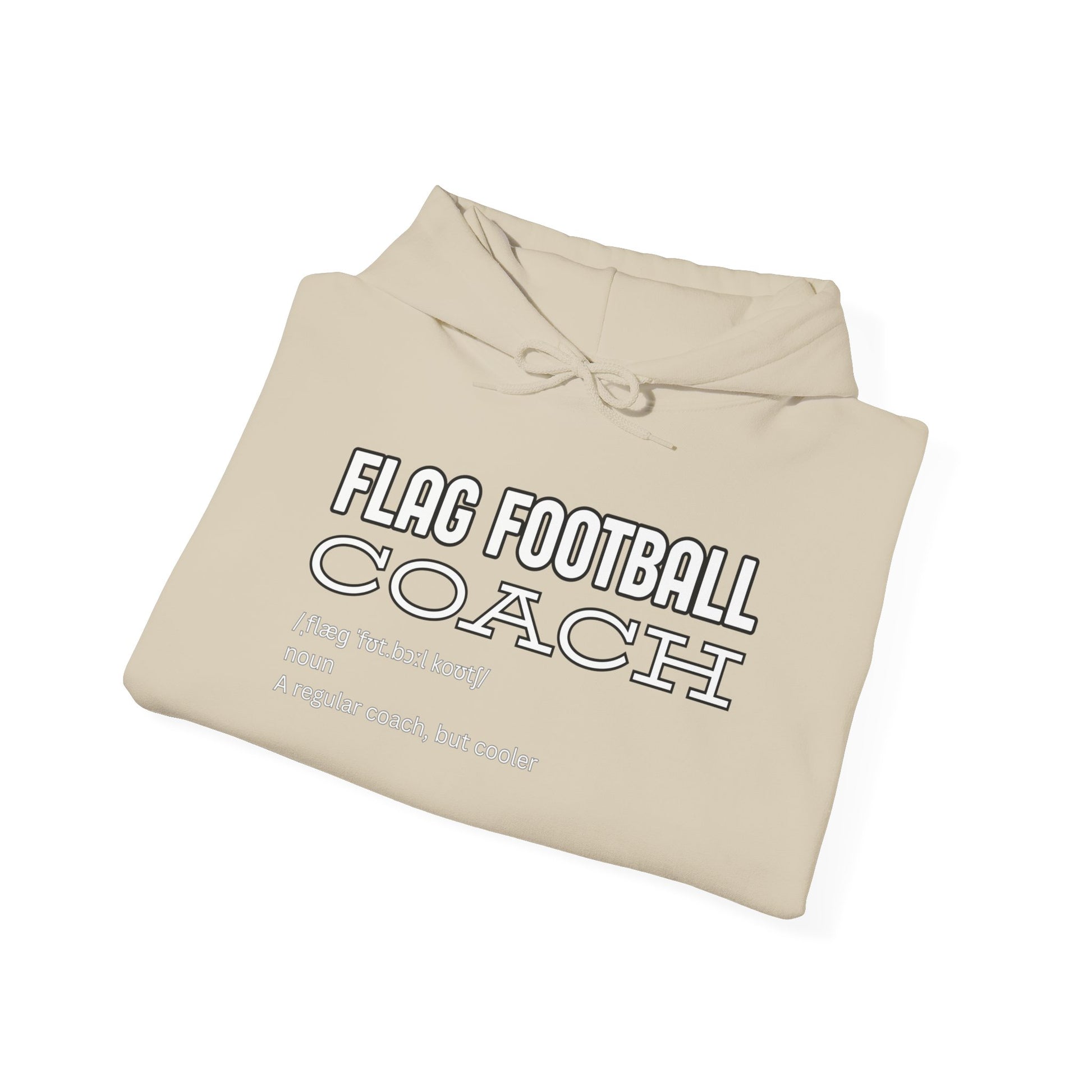 Folded sand hoodie front showing white "FLAG FOOTBALL COACH – Like a Regular Coach but Cooler" print