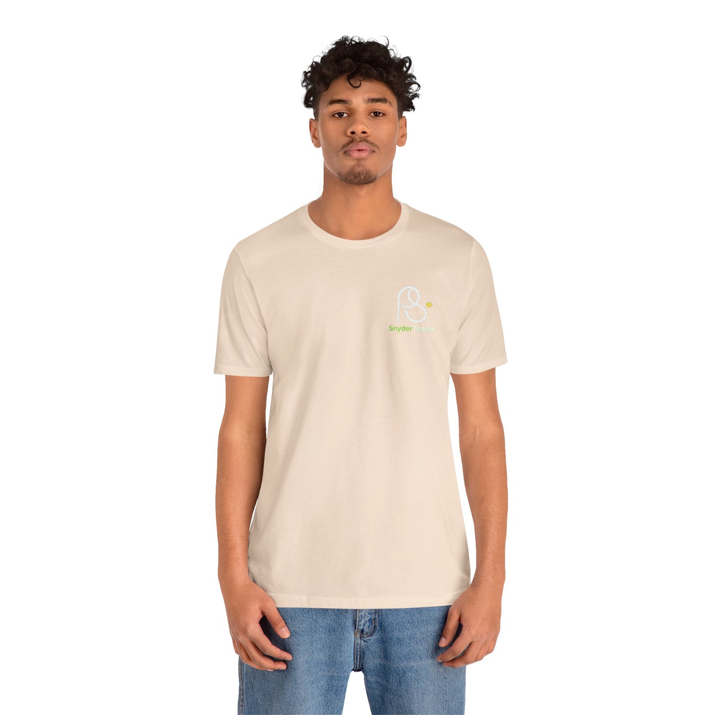 Male model front view in light beige Coach Pete Snyder tee with chest PS logo, paired with jeans
