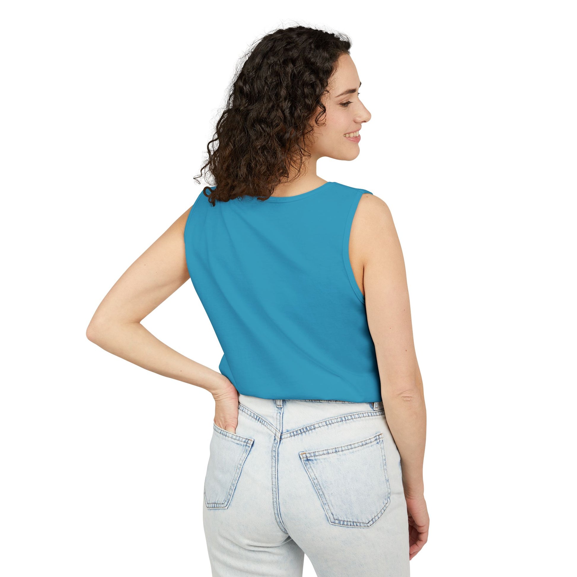 Side view of woman in plain teal tank top paired with light jeans, casual trader style