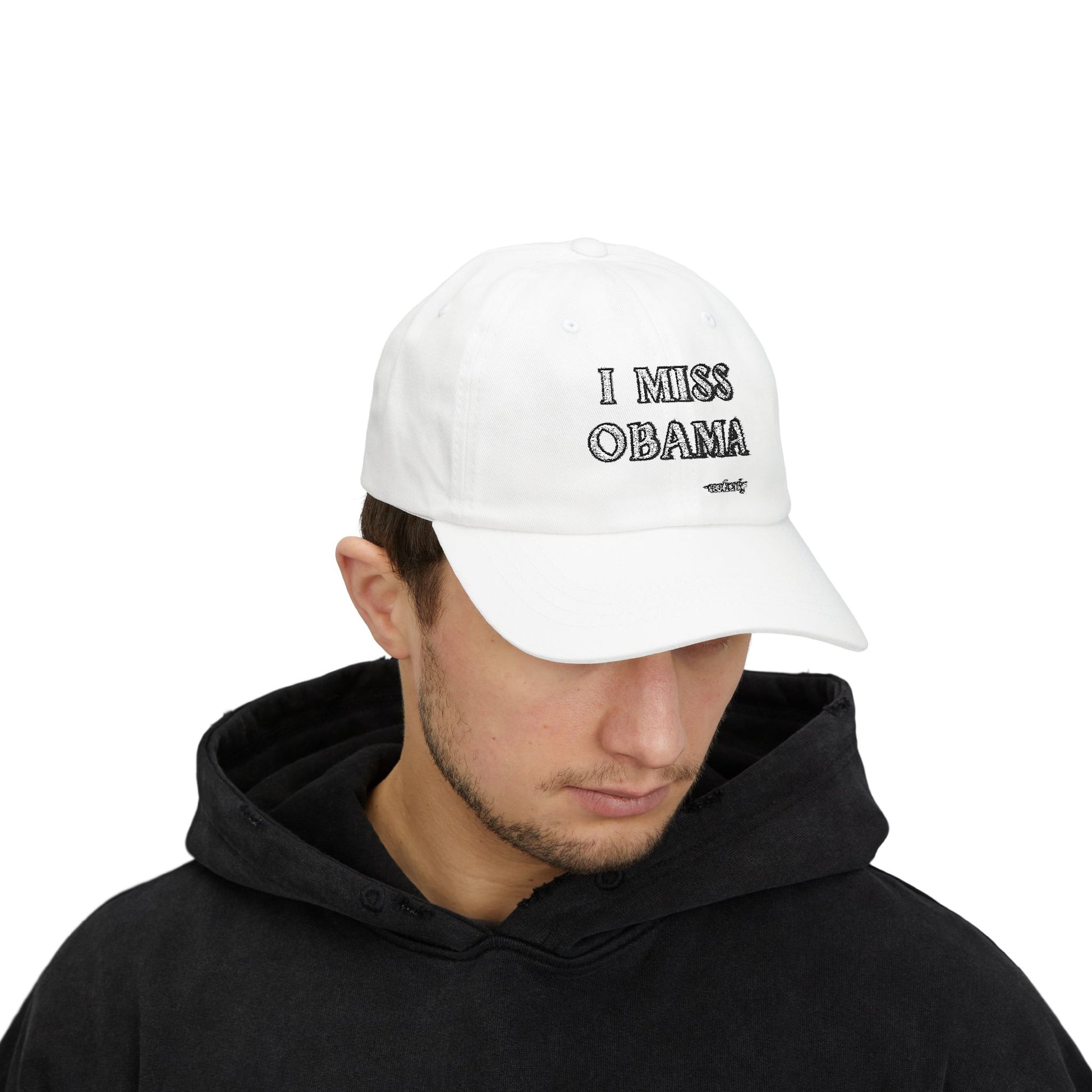 Model in black hoodie wearing white "I MISS OBAMA -nobody" dad hat, front embroidery view