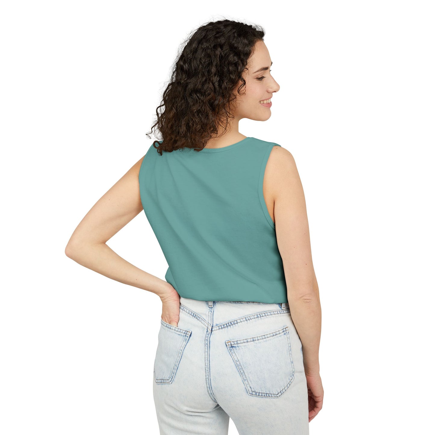3/4 back side view of curly-haired woman in seafoam green tank top and light jeans