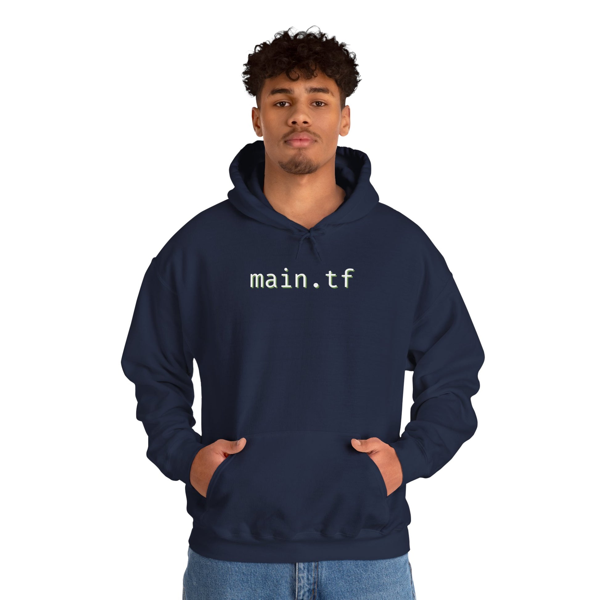 Curly-haired guy posing front in navy hoodie with "main.tf" print, hands pocketed