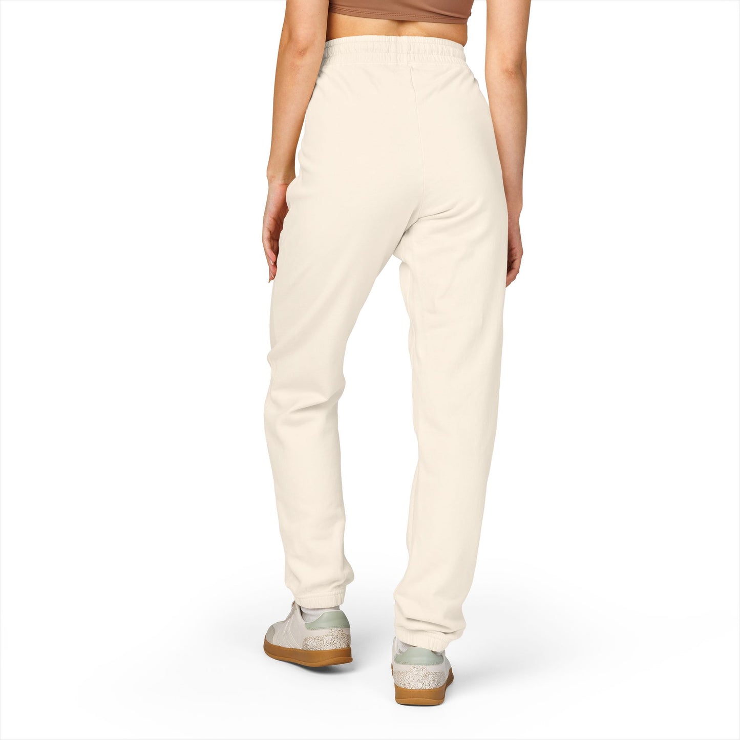 Back view of model in cream Zeta sweatpants, cozy fleece joggers with cuffed ankles