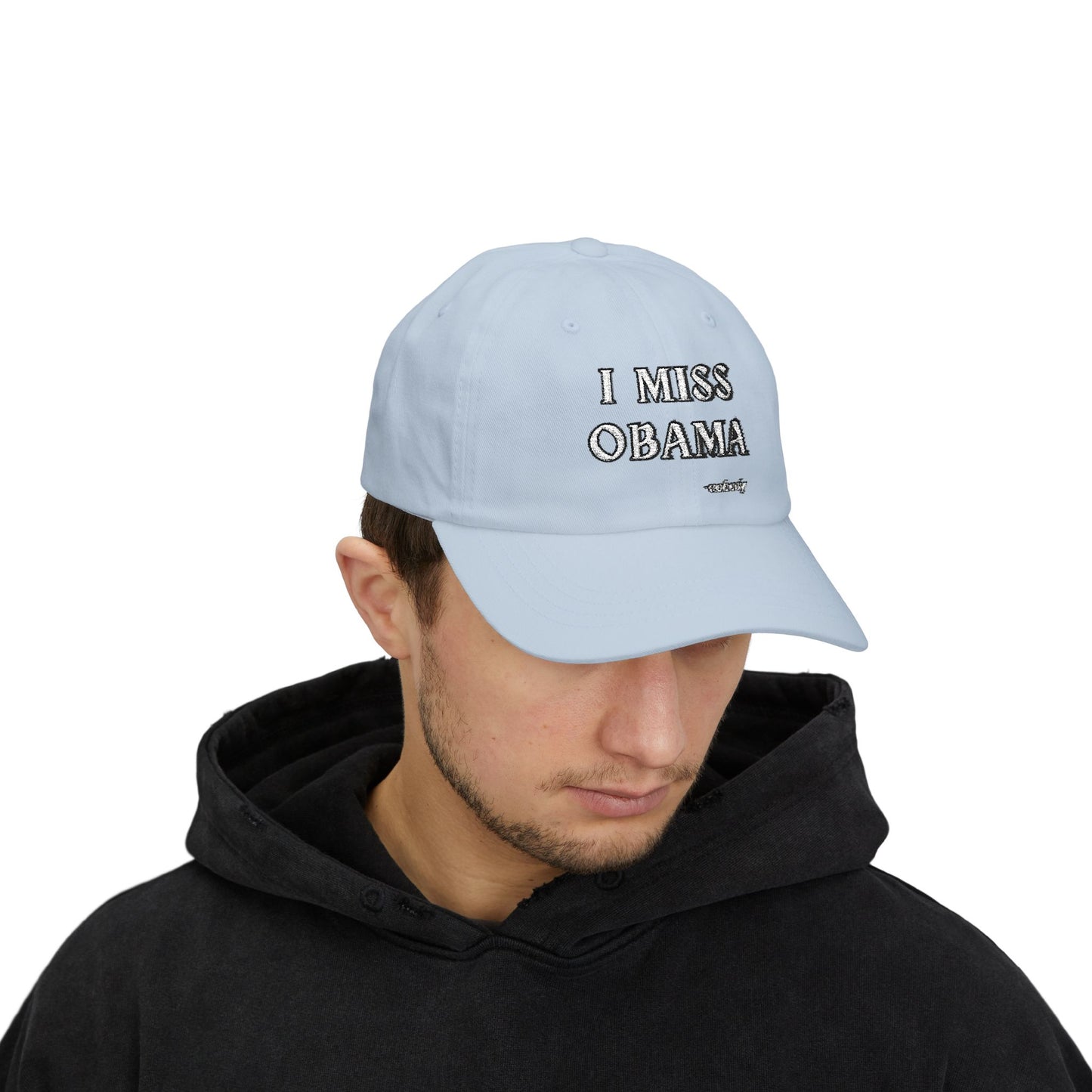 Man model in black hoodie sporting light blue "I MISS OBAMA -nobody" embroidered dad hat upfront