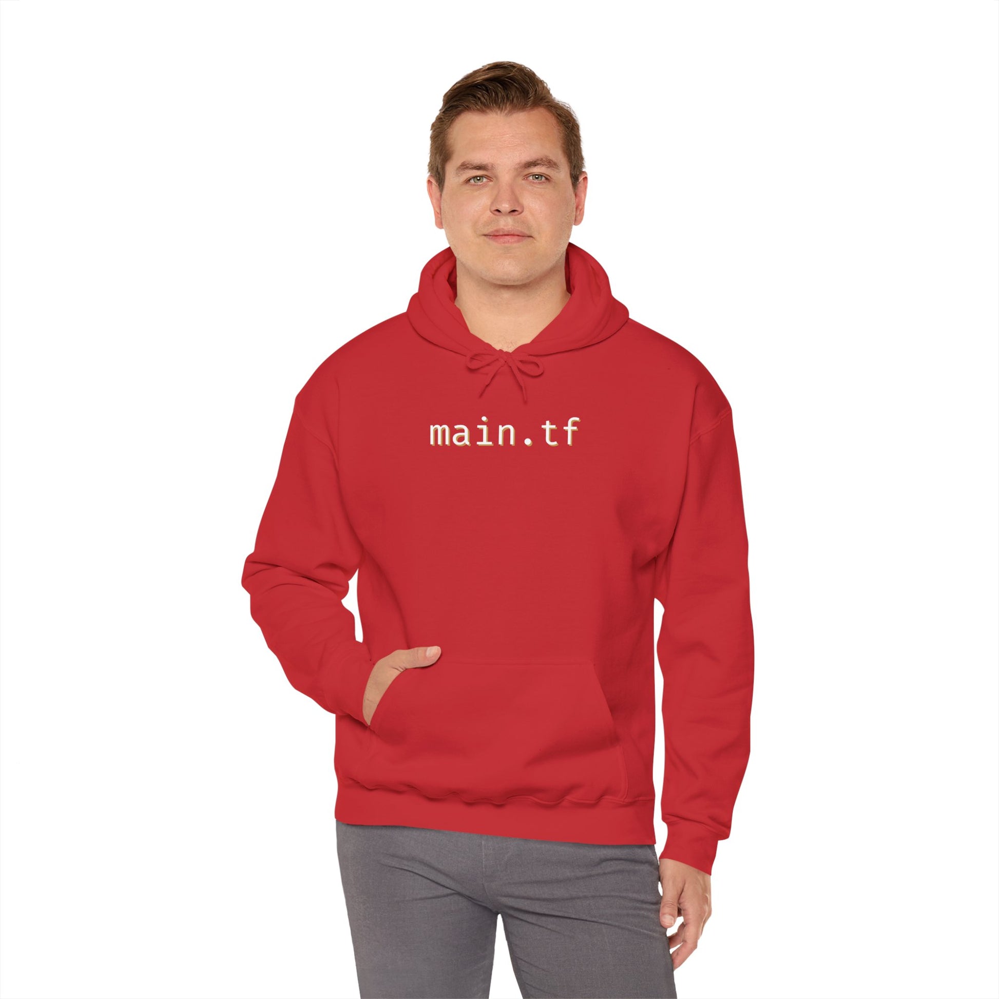 Model in red hoodie rocking clean white "main.tf" chest print, hand tucked in kangaroo pocket