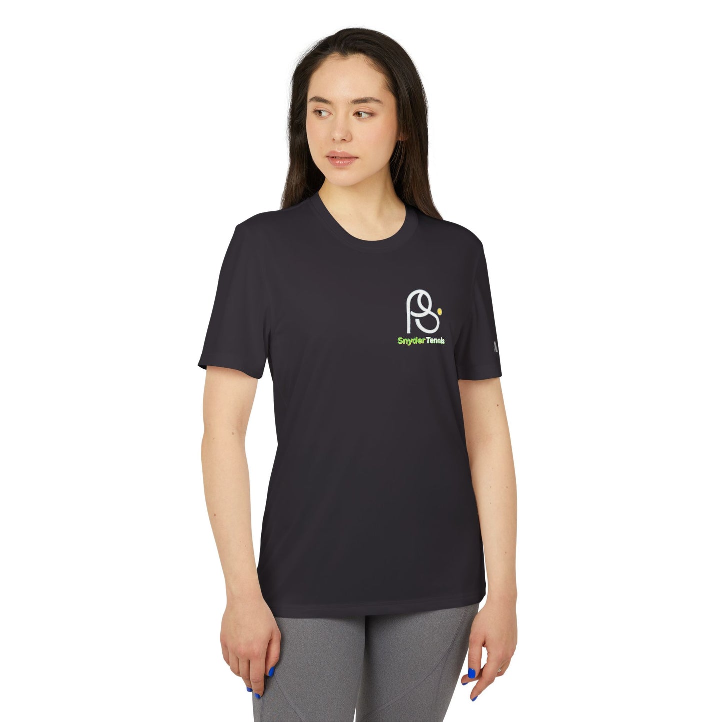Female model in black adidas tee, side-front view flaunting PB Tennis logo, chill gray leggings vibe