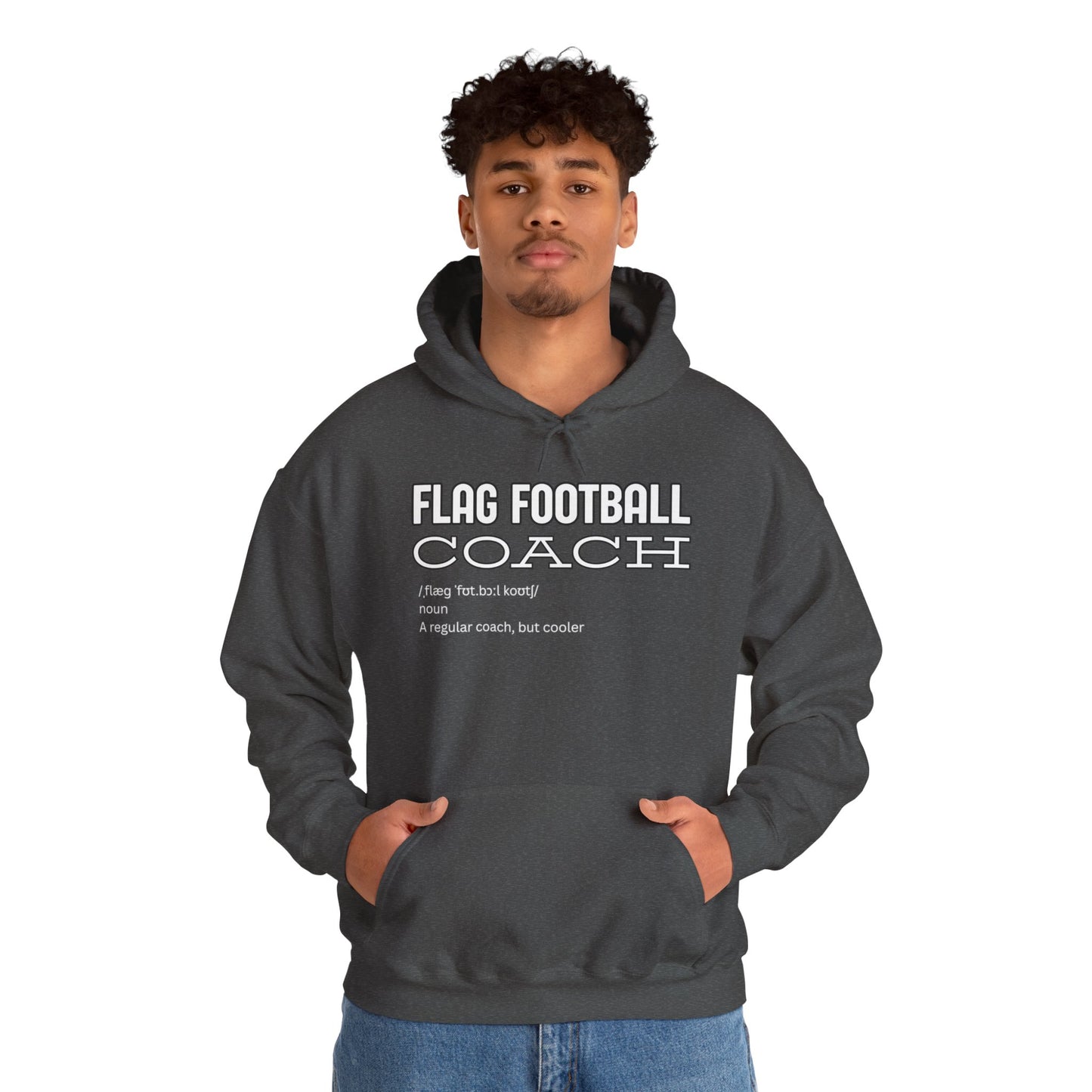 Male model with curly hair rocking heather gray hoodie front, bold white "FLAG FOOTBALL COACH – cooler than regular" text