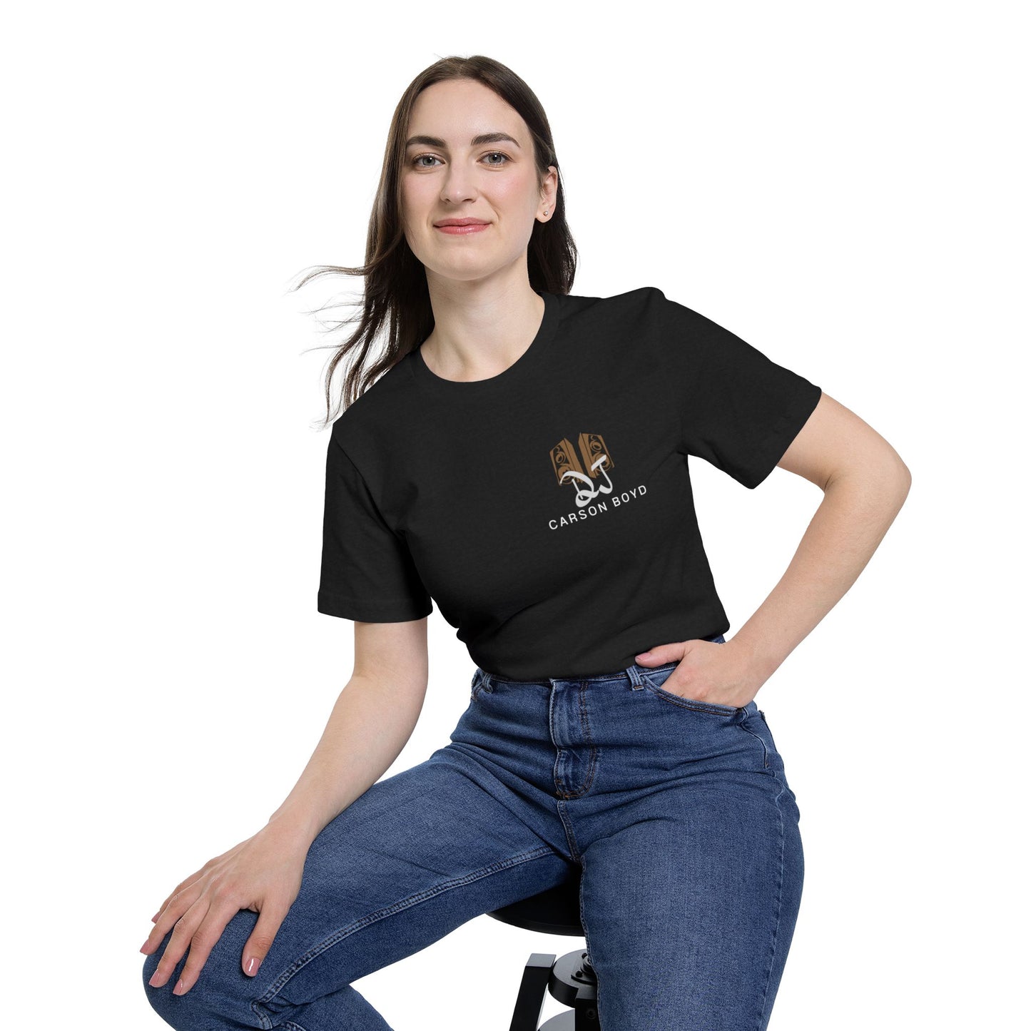 Female model sitting in black tee, front view with subtle tan "DJ Carson Boyd" chest logo