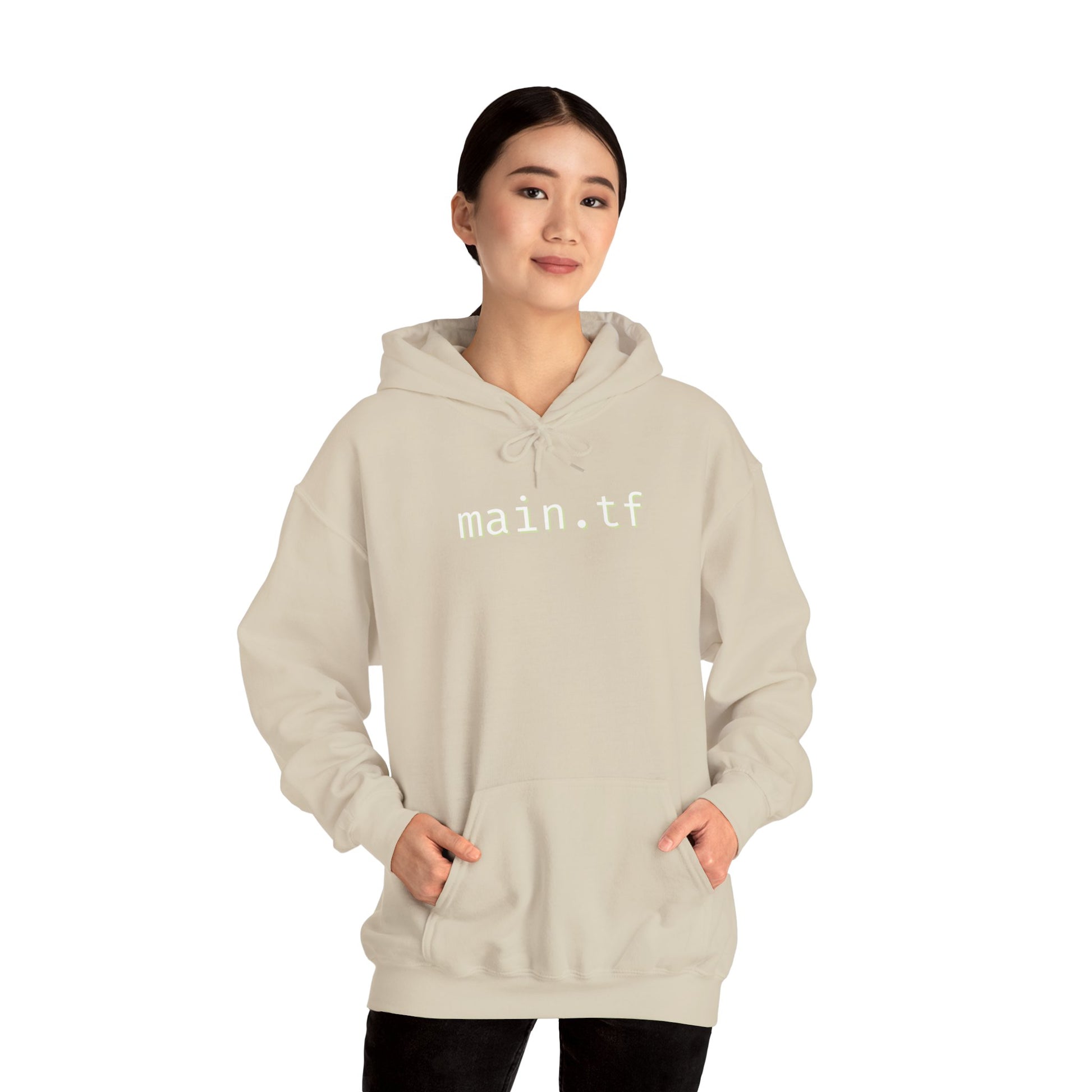 Folded light beige hoodie displaying crisp "main.tf" chest text