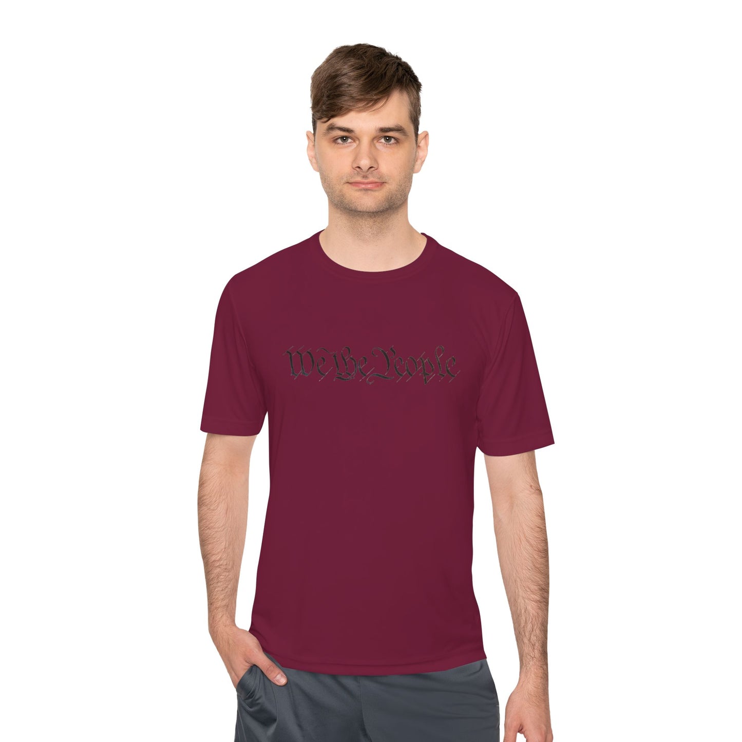 Male model front view in maroon moisture-wicking tee with black cursive "We the People" across chest