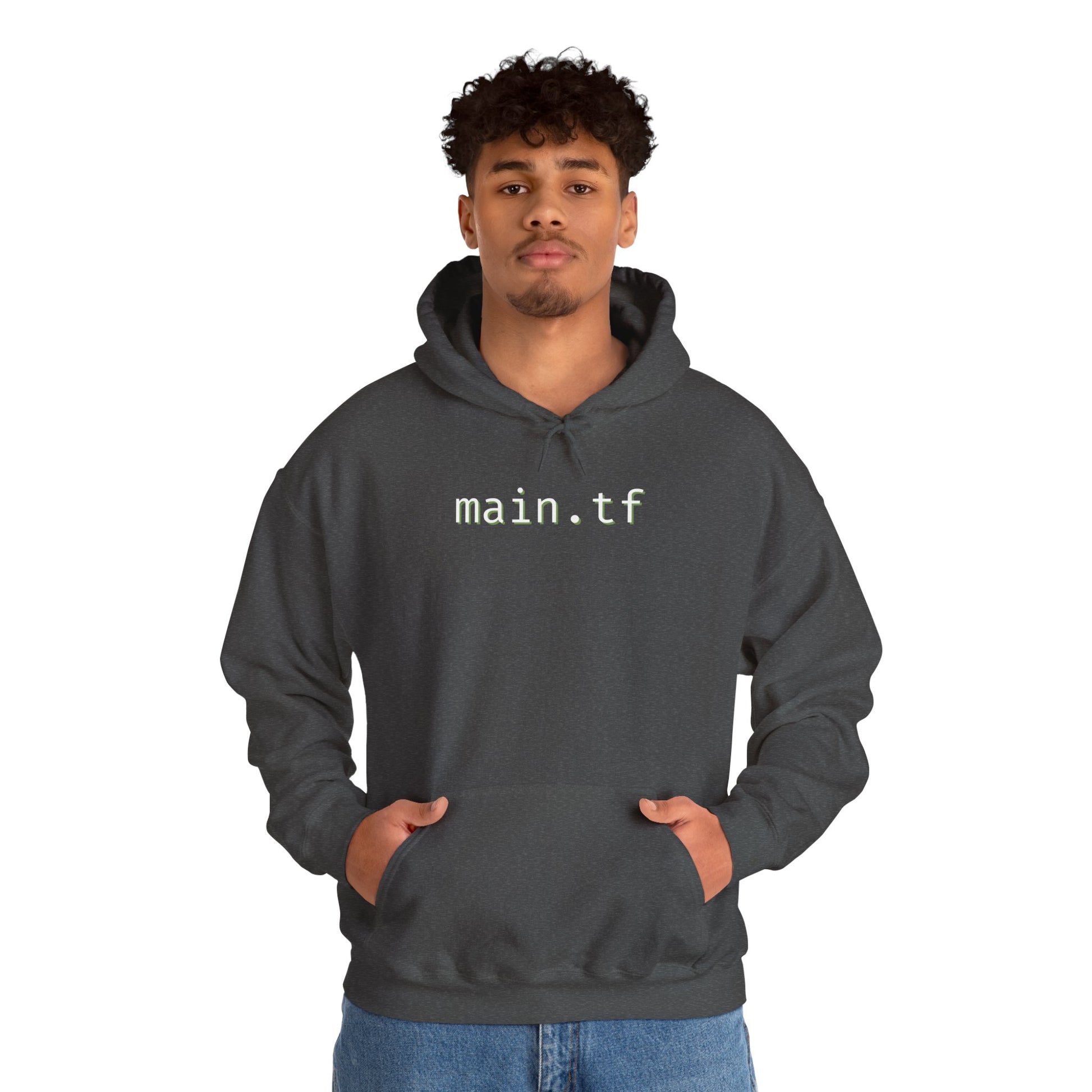 Curly-haired man posing front in dark heather gray hoodie with "main.tf" cyan print, relaxed fit