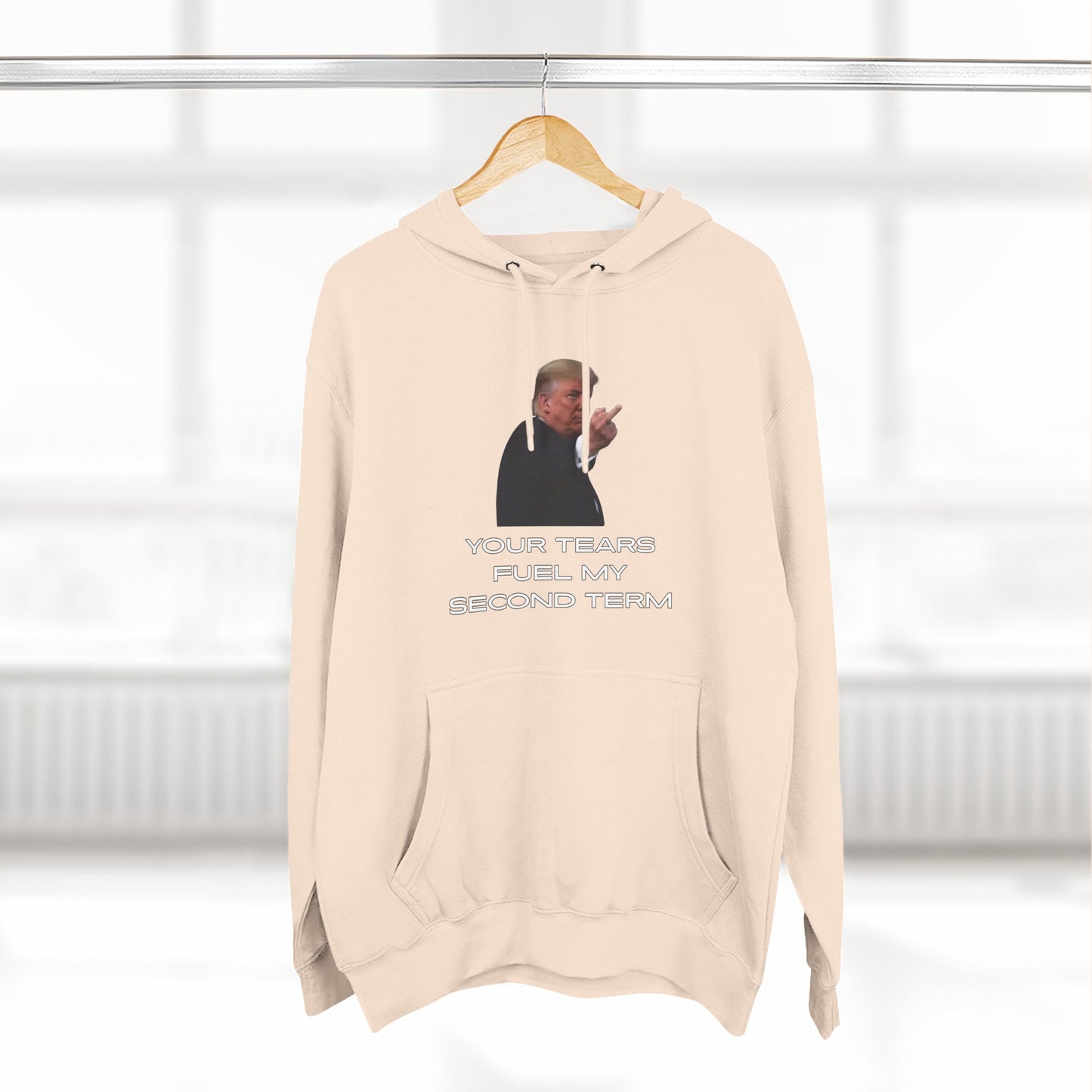 Hanging oatmeal heather hoodie, front view Trump pointing with "YOUR TEARS FUEL MY SECOND TERM" text