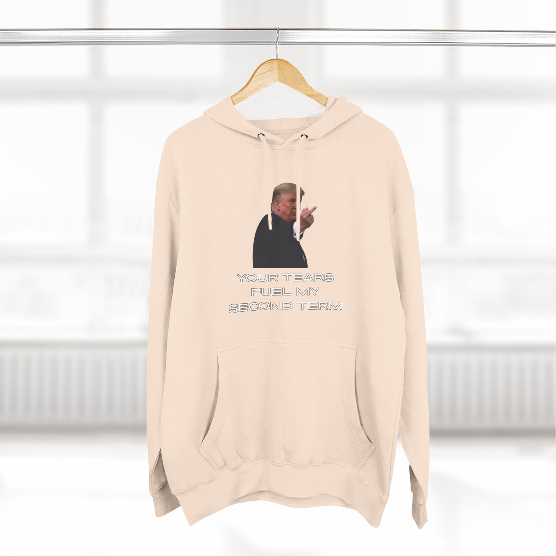 Hanging oatmeal heather hoodie, front view Trump pointing with "YOUR TEARS FUEL MY SECOND TERM" text