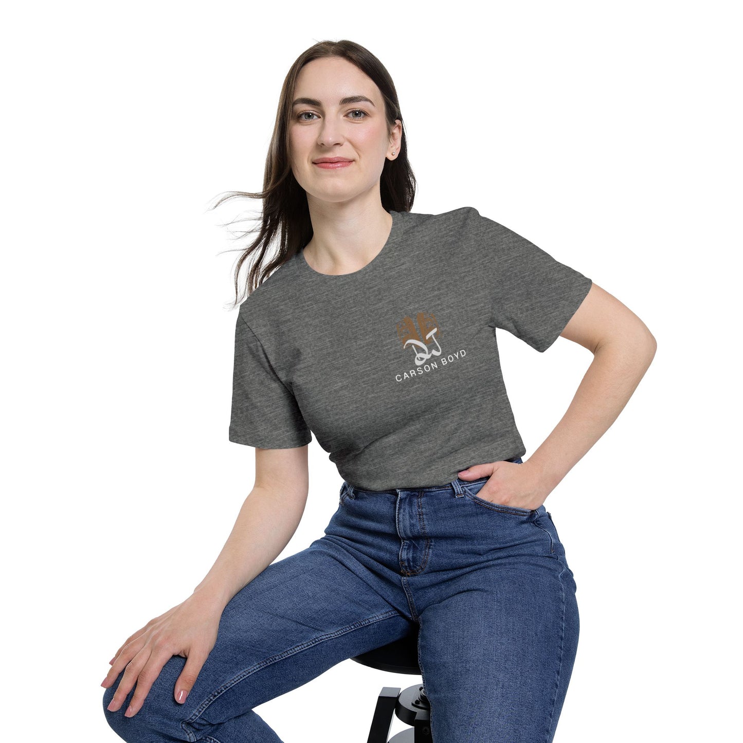 Female model chilling on stool in heather gray crew tee, subtle tan DJ Carson Boyd logo on chest pocket vibe