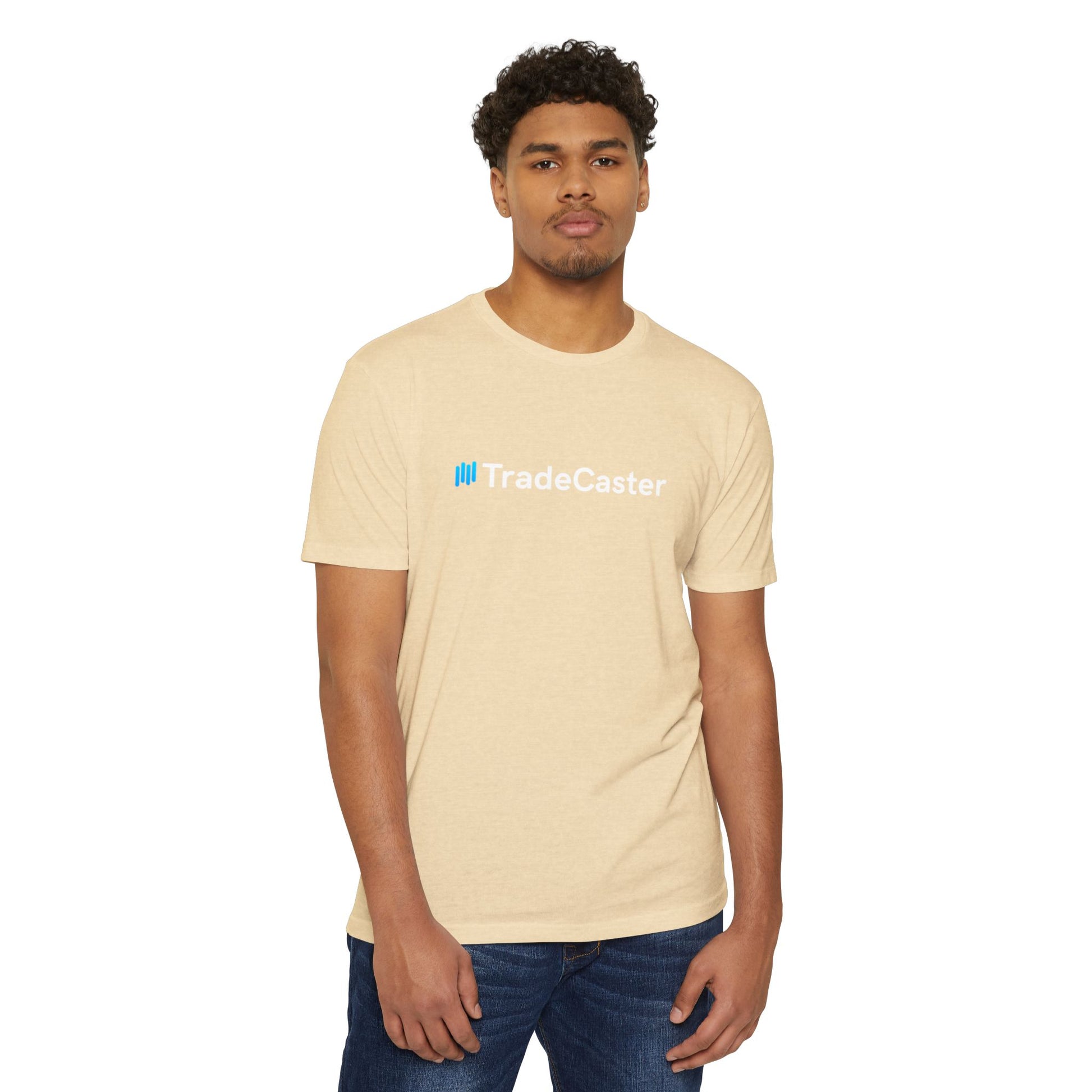 Male model front view in beige CVC t-shirt with blue "||TradeCaster" logo, hands in jeans pockets