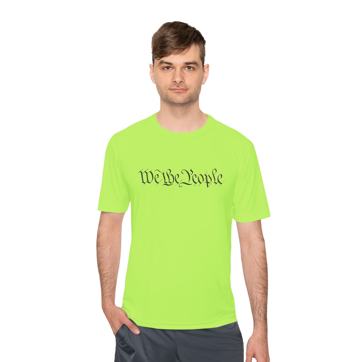 Front view of guy in bright neon green athletic tee printed with flowing "We the People" text