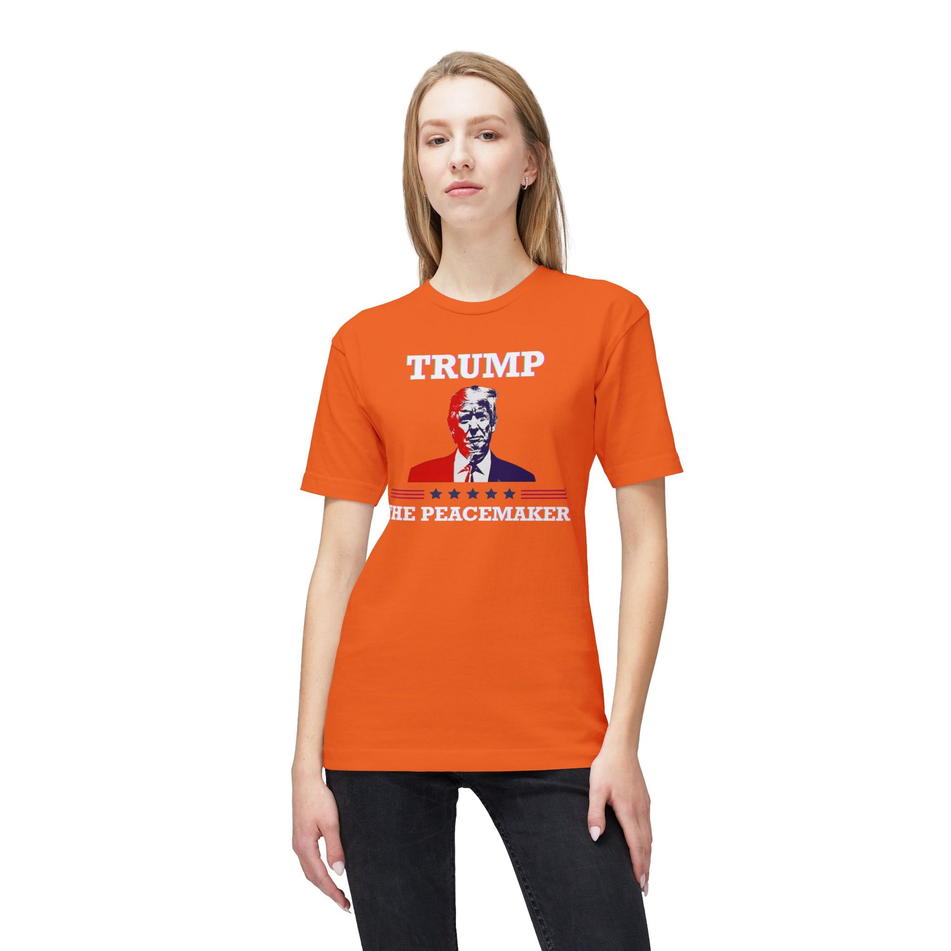 Blonde model in front view of bright orange "TRUMP HE PEACEMAKER" tee with satirical portrait