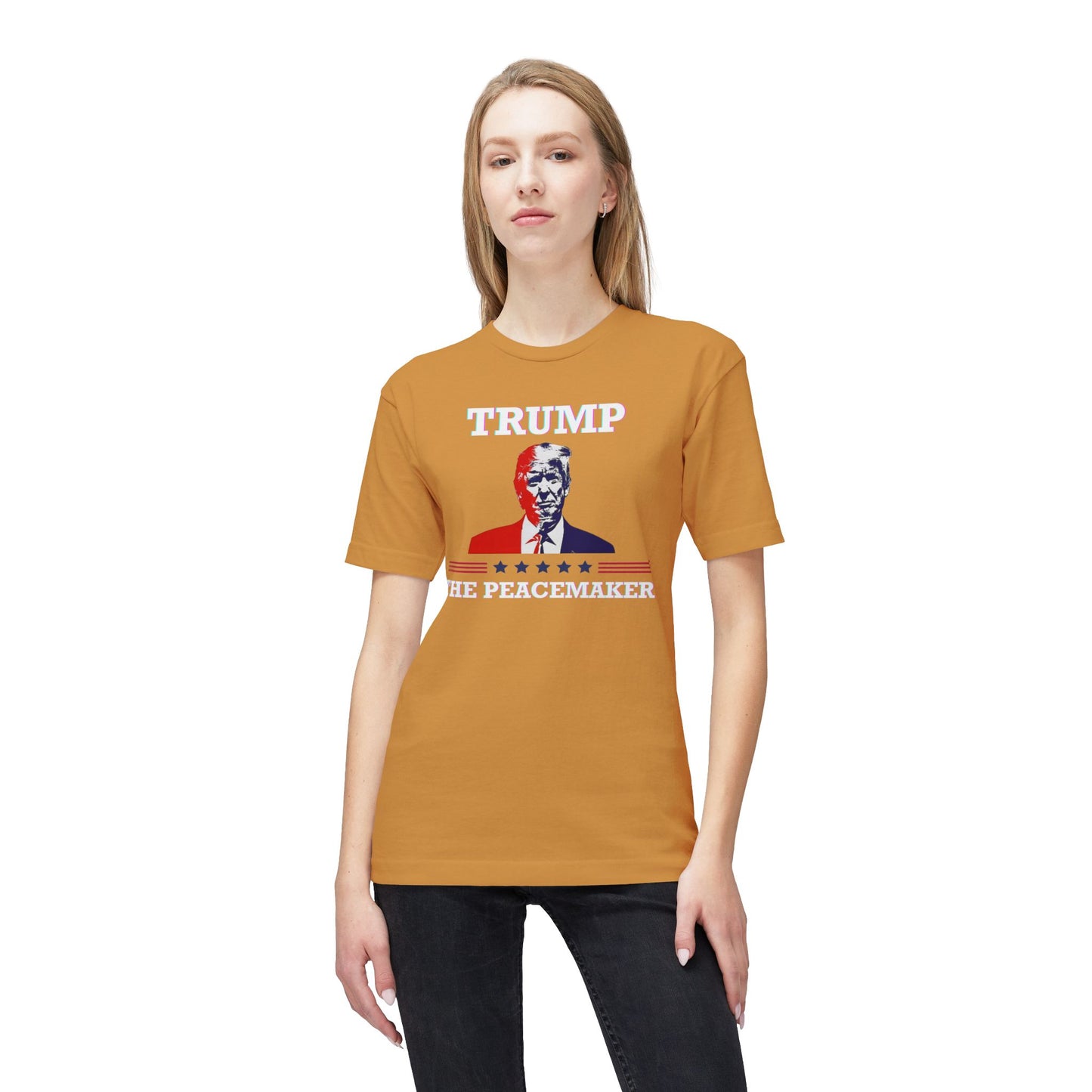 Blonde model rocks front view of orange tee with "TRUMP", Trump portrait, "HE ★ PEACEMAKER" — peacemaker glow-up