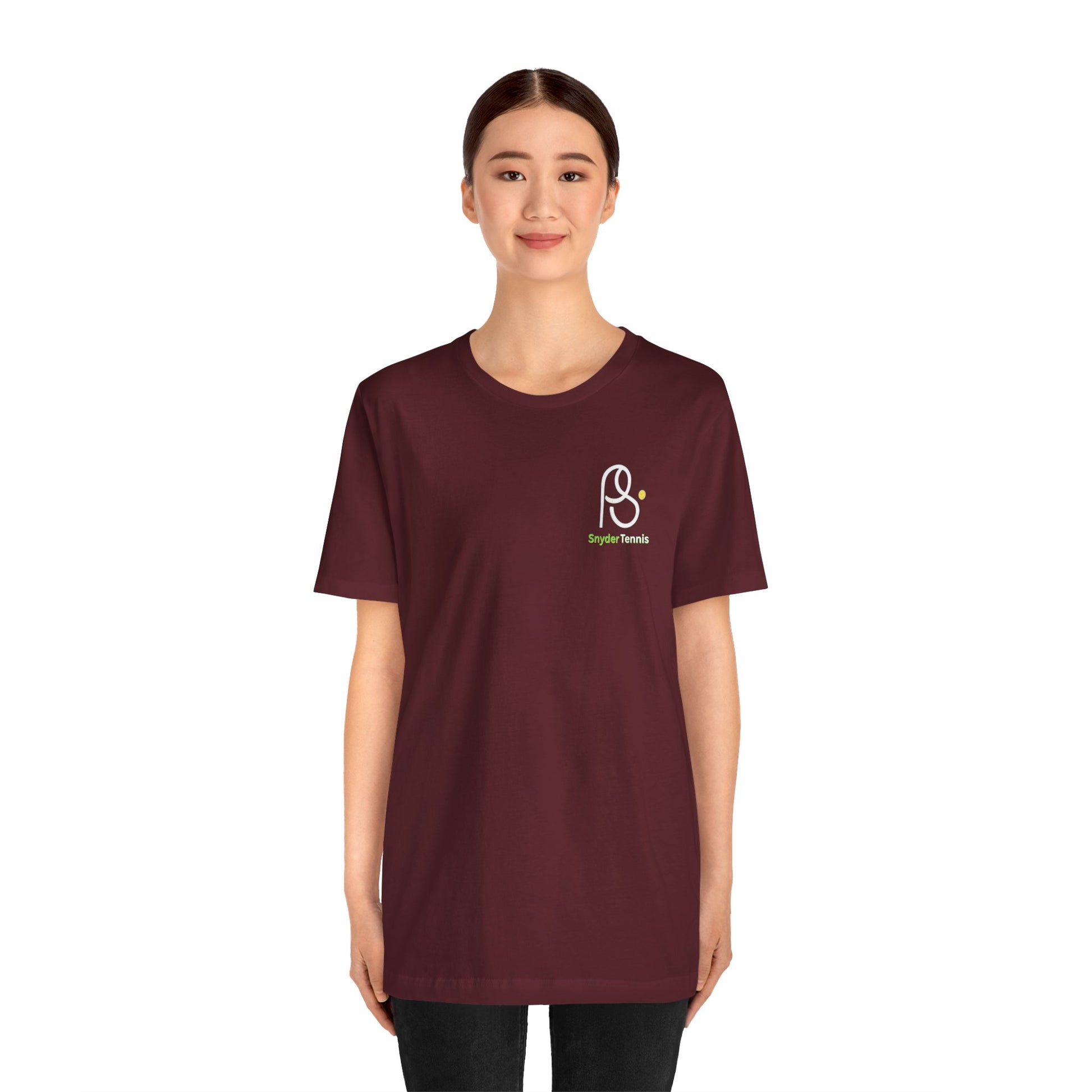 Female model front view in maroon t-shirt, chest white PS emblem and green "Snyder Tennis" detail