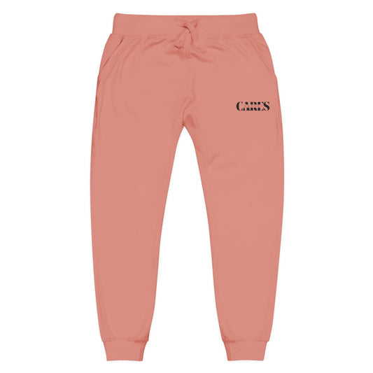 Front view of dusty rose jogger sweatpants with black "CARES" thigh embroidery, elastic waist, pockets, cuffed hems