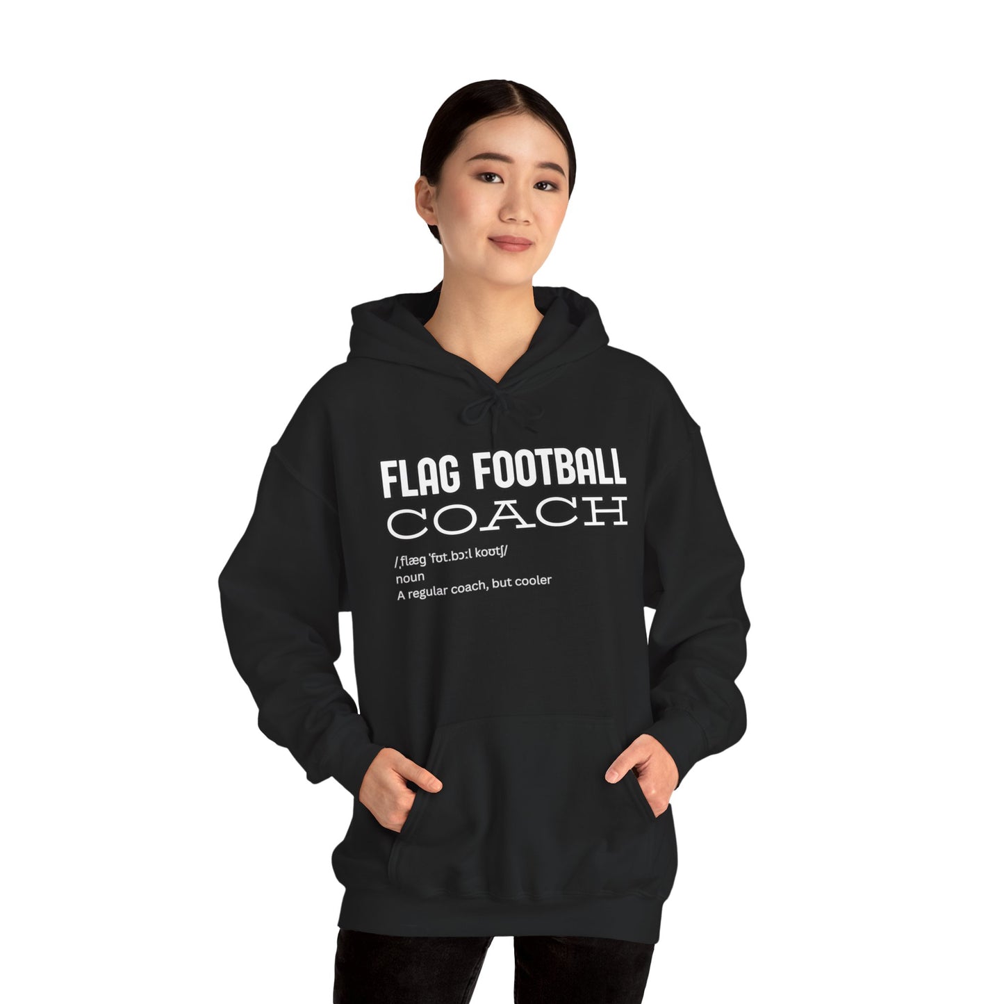 Asian woman modeling front of black Flag Football Coach hoodie, hands in pockets