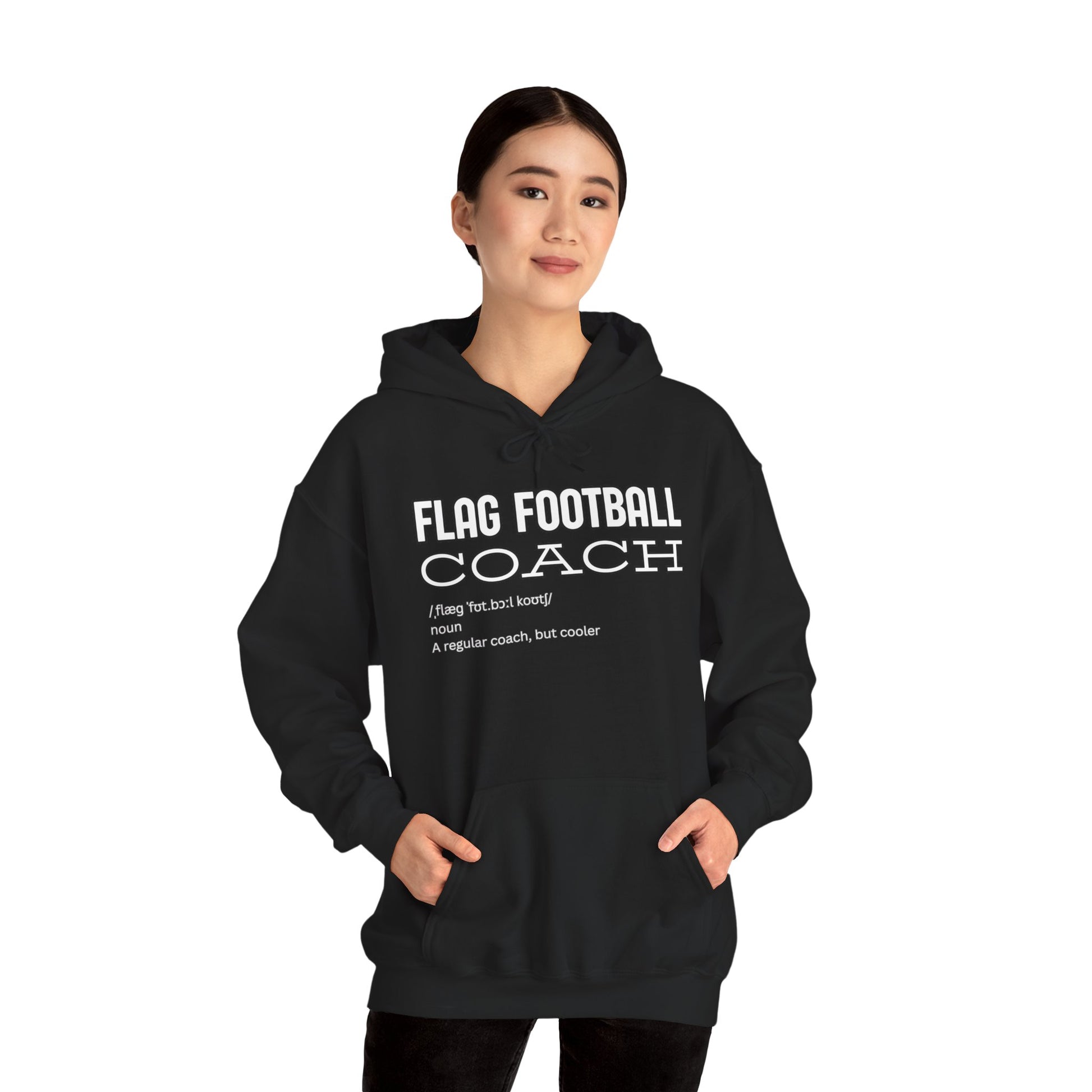 Asian woman modeling front of black Flag Football Coach hoodie, hands in pockets