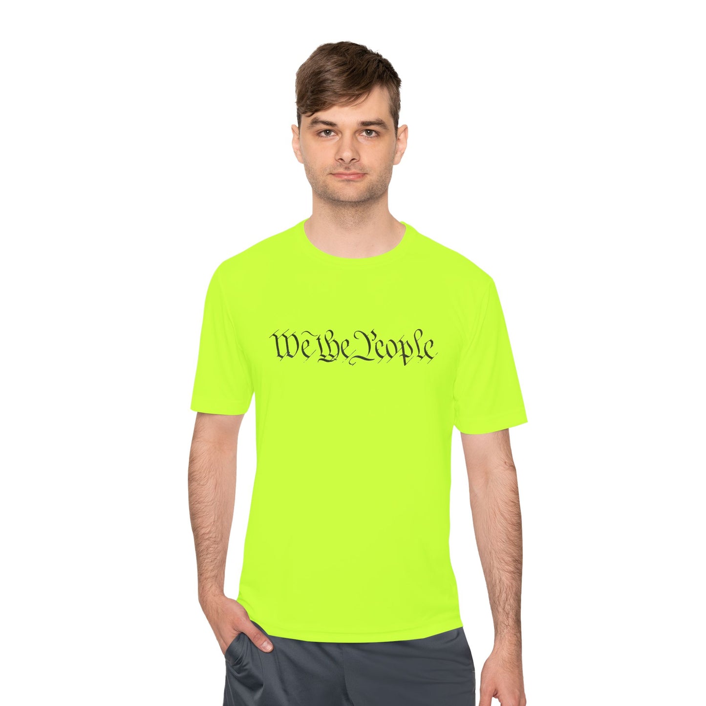 Male model flexing casual in neon green moisture-wicking tee with cursive "We the People" print across chest